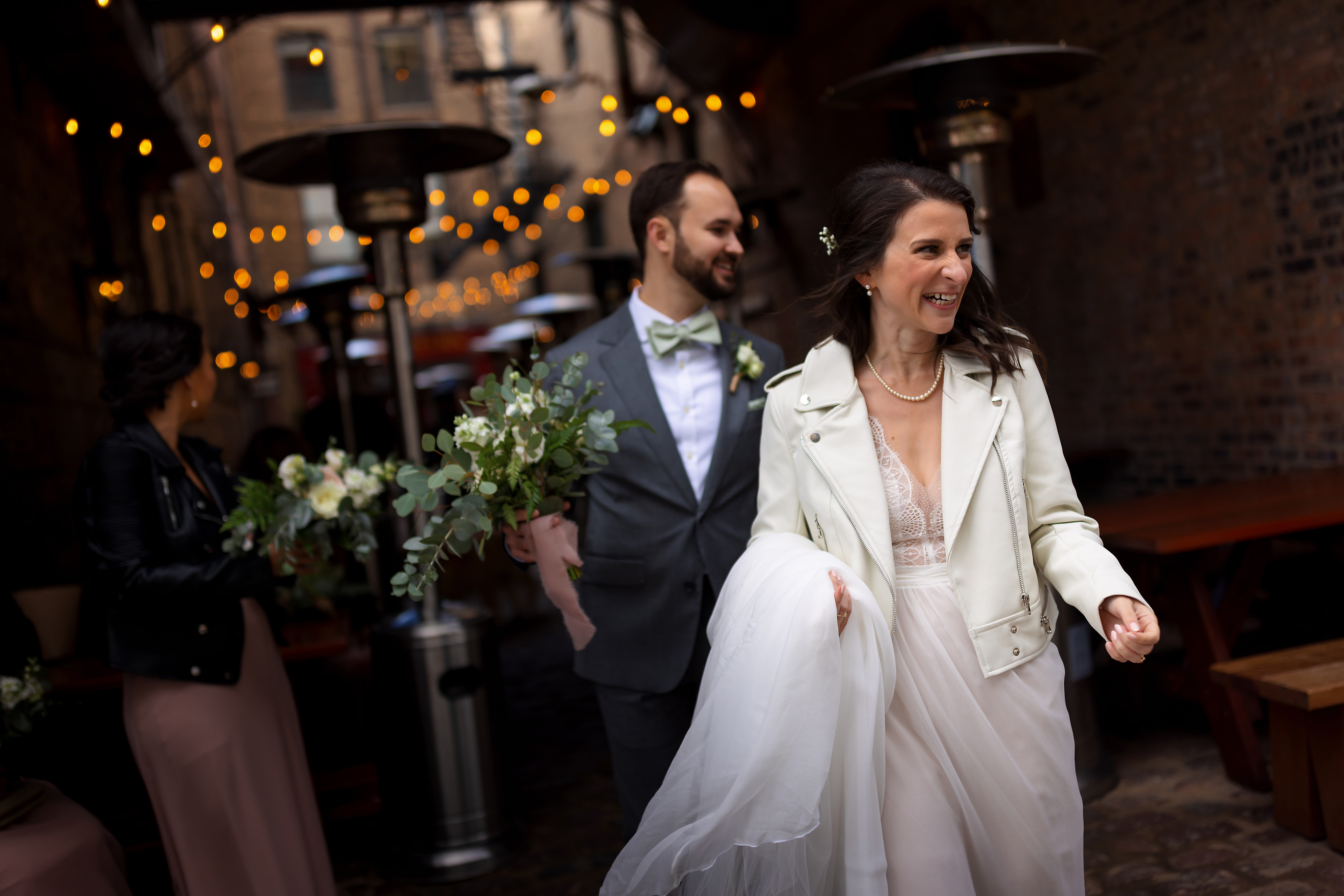 Bride and groom leave Green Street Smoked Meats in Chicago's West Loop neighborhood after taking wedding portraits.