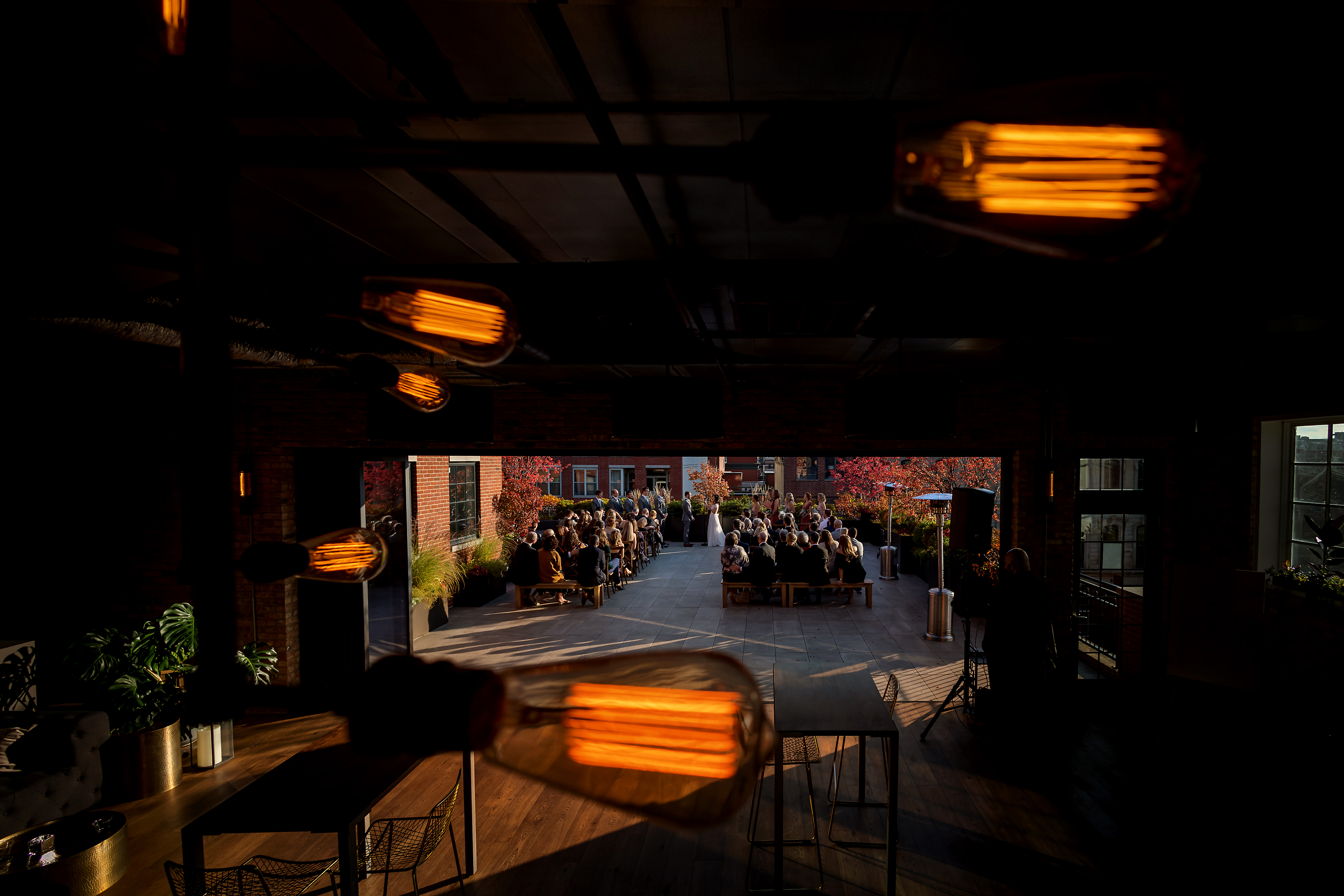 Wide angle view of rooftop wedding ceremony at Loft Lucia in Chicago's West Loop neighborhood.