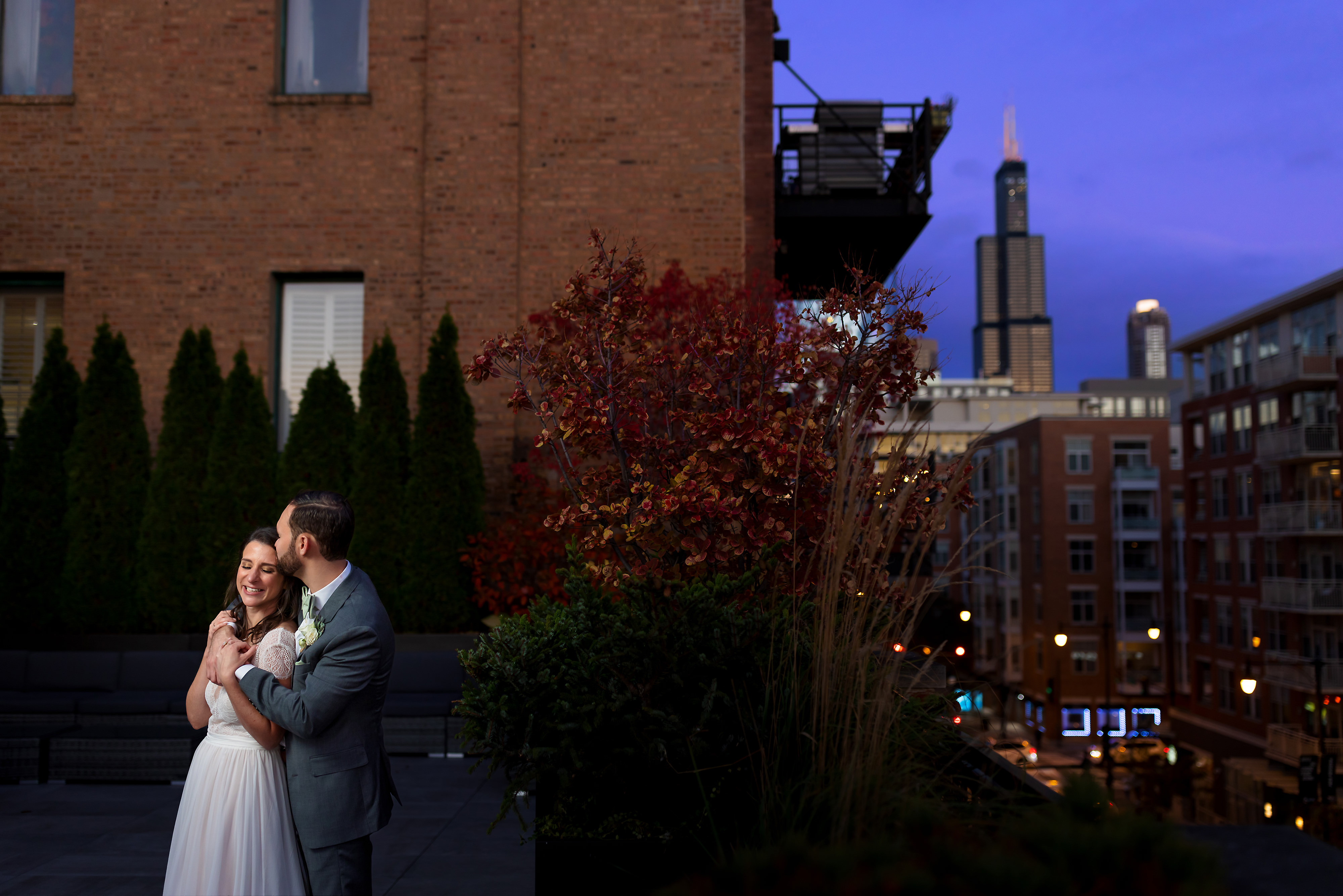 Bride and groom pose for portrait on the rooftop during wedding at Loft Lucia in Chicago's West Loop neighborhood.