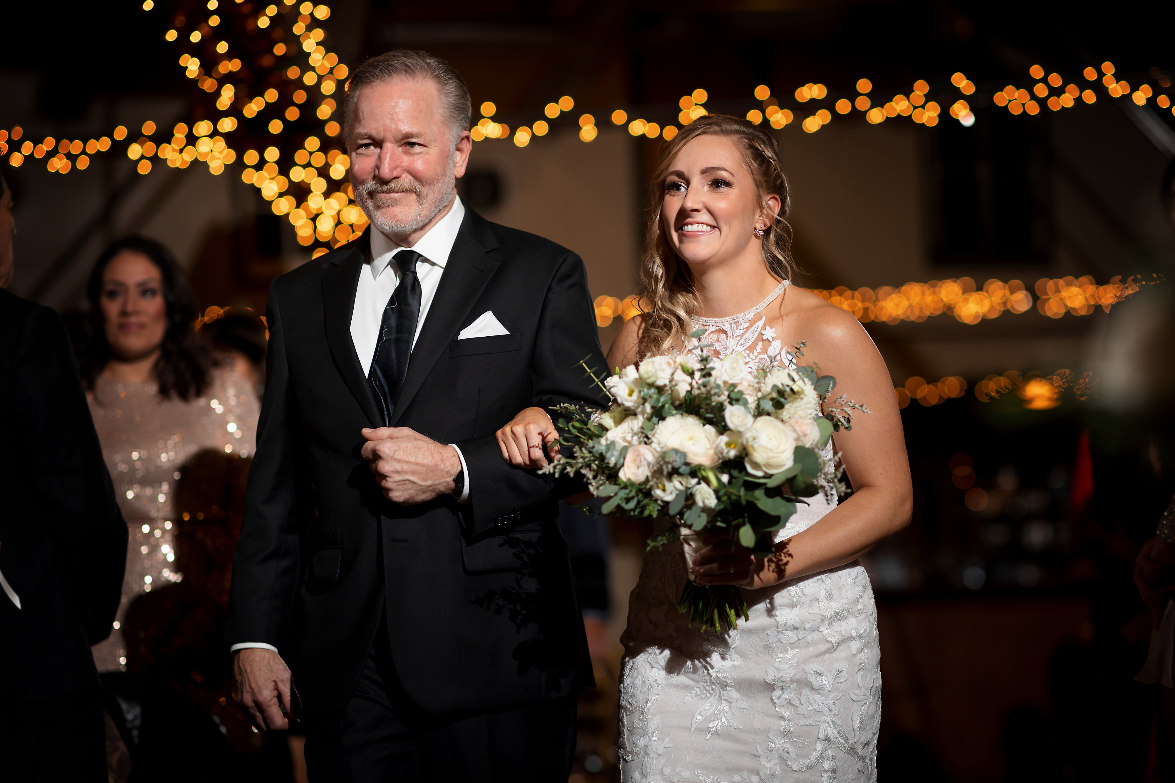 Bride walks down the aisle with her father during wedding ceremony at Two Brothers Brewing in Aurora, Illinois