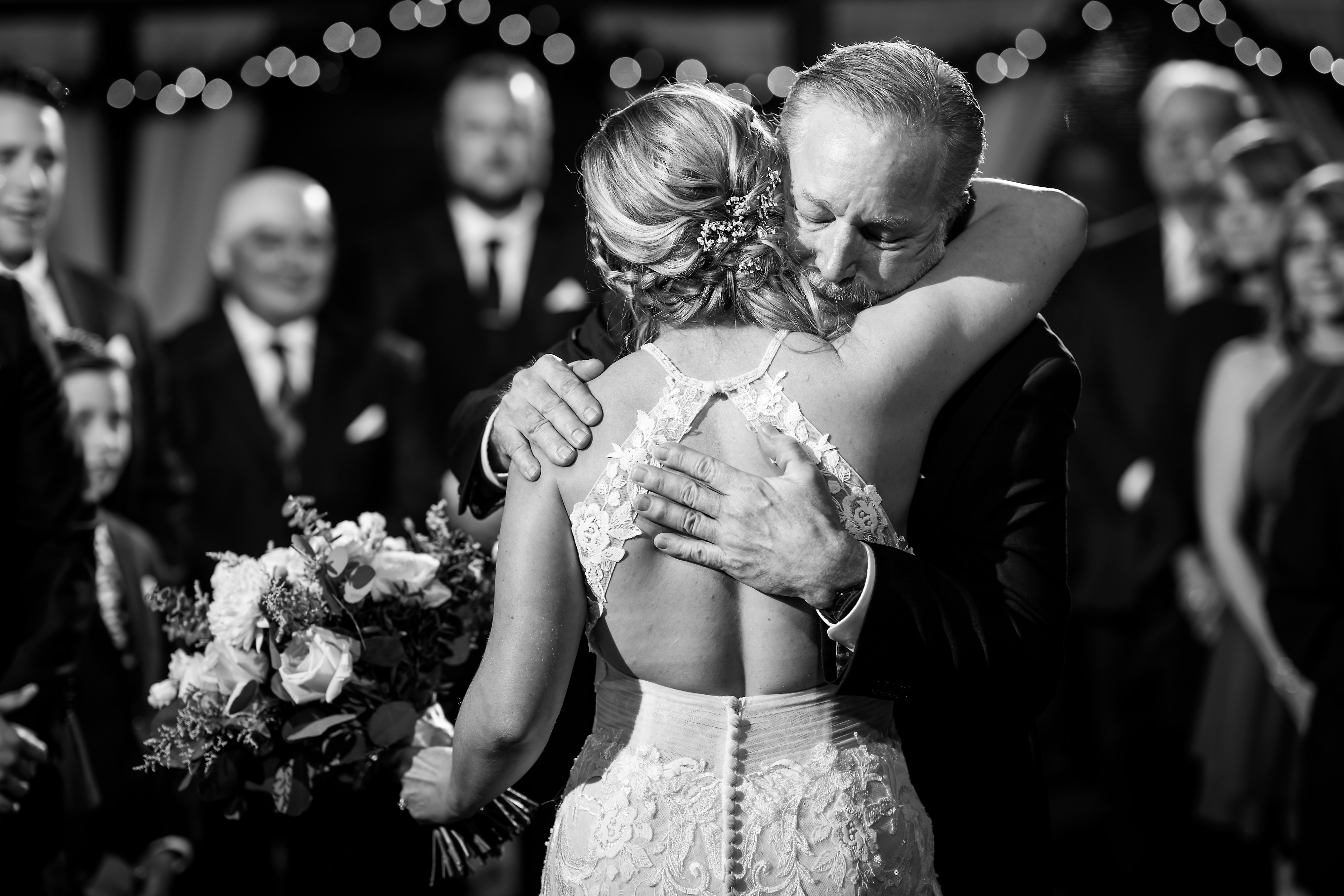 Bride hugs father during wedding ceremony at Two Brothers Brewing in Aurora, Illinois