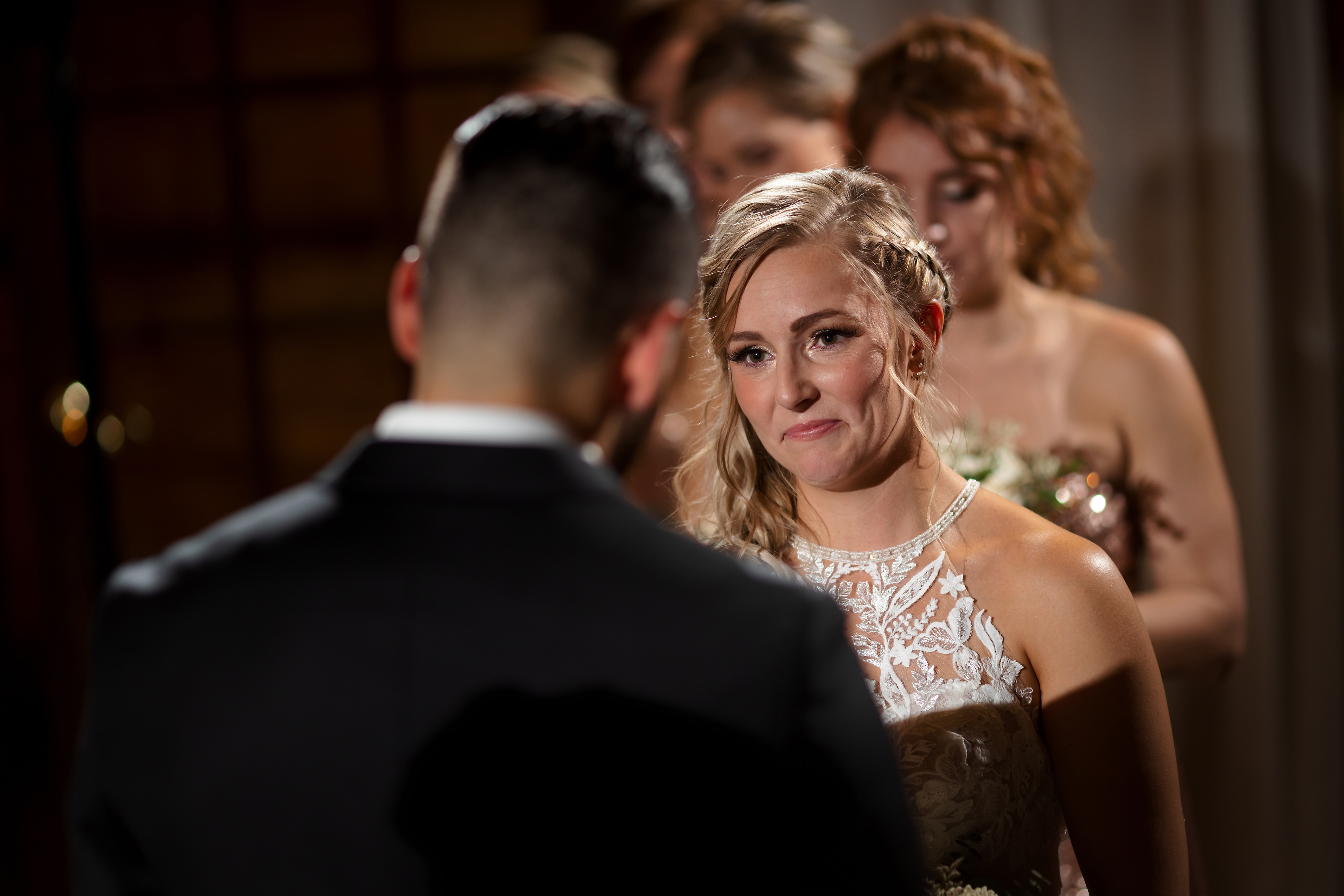 Bride looks at groom during wedding ceremony at Two Brothers Brewing in Aurora, Illinois