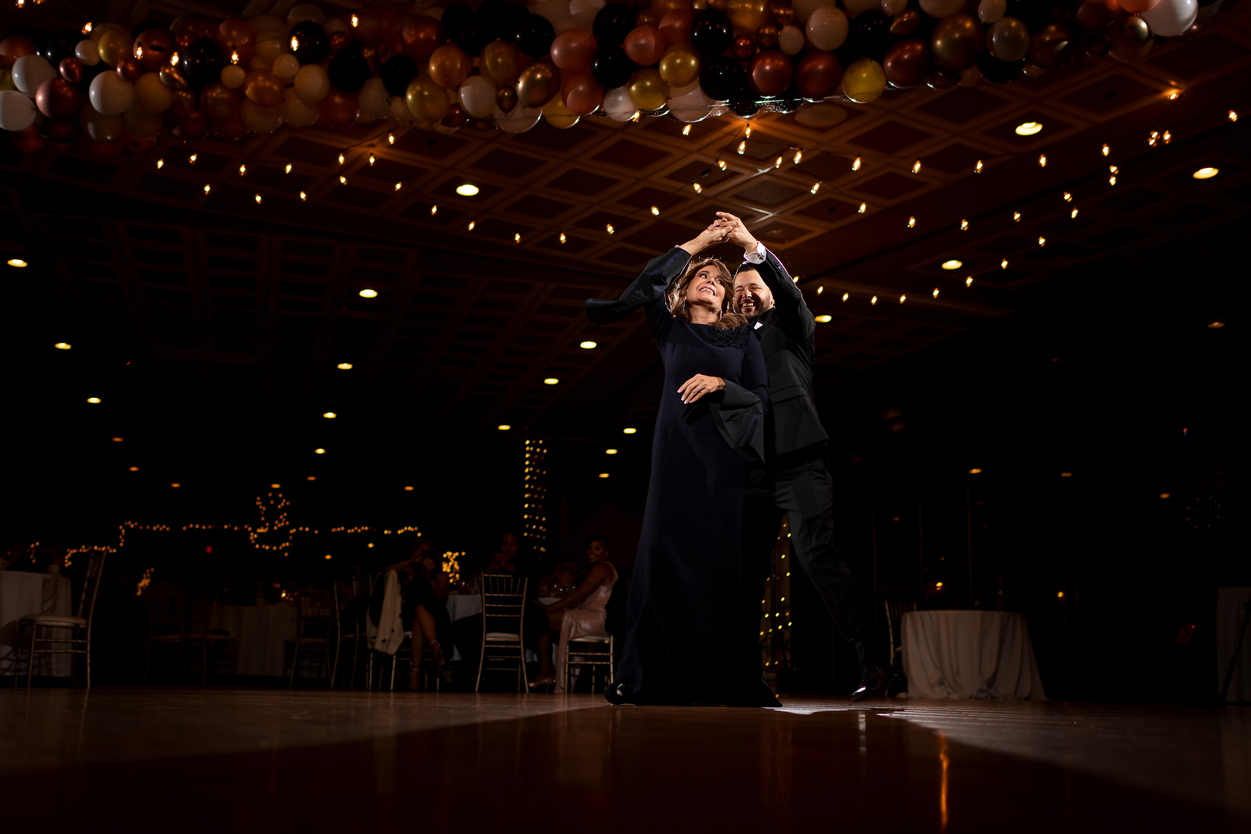 Groom dances with mom during wedding reception at Two Brothers Brewery in Aurora, Illinois