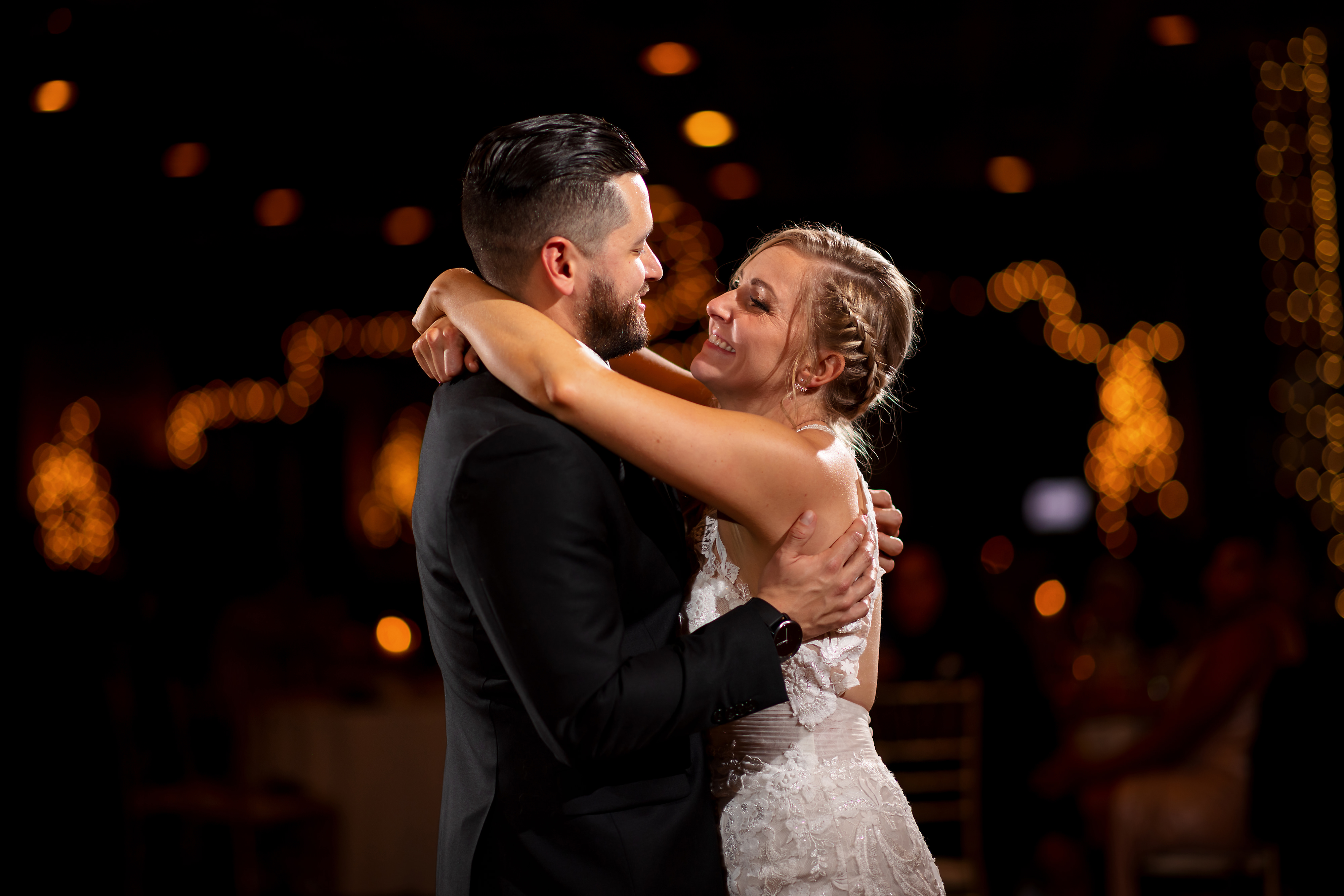 Bride and groom dance together during wedding reception at Two Brothers Brewery in Aurora, Illinois