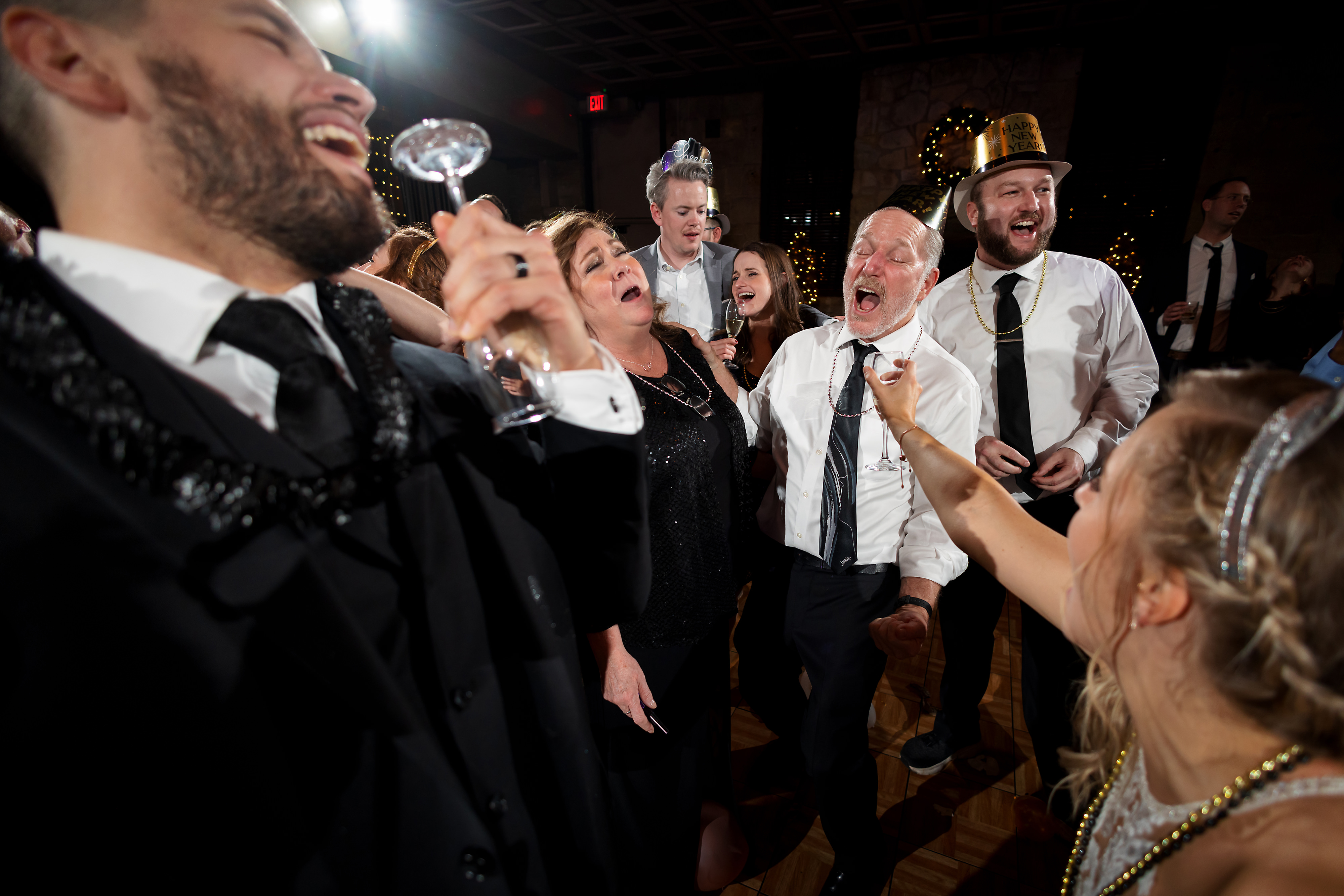 Wedding guests dance during winter wedding at Two Brothers Roundhouse Brewery in Aurora, Illinois