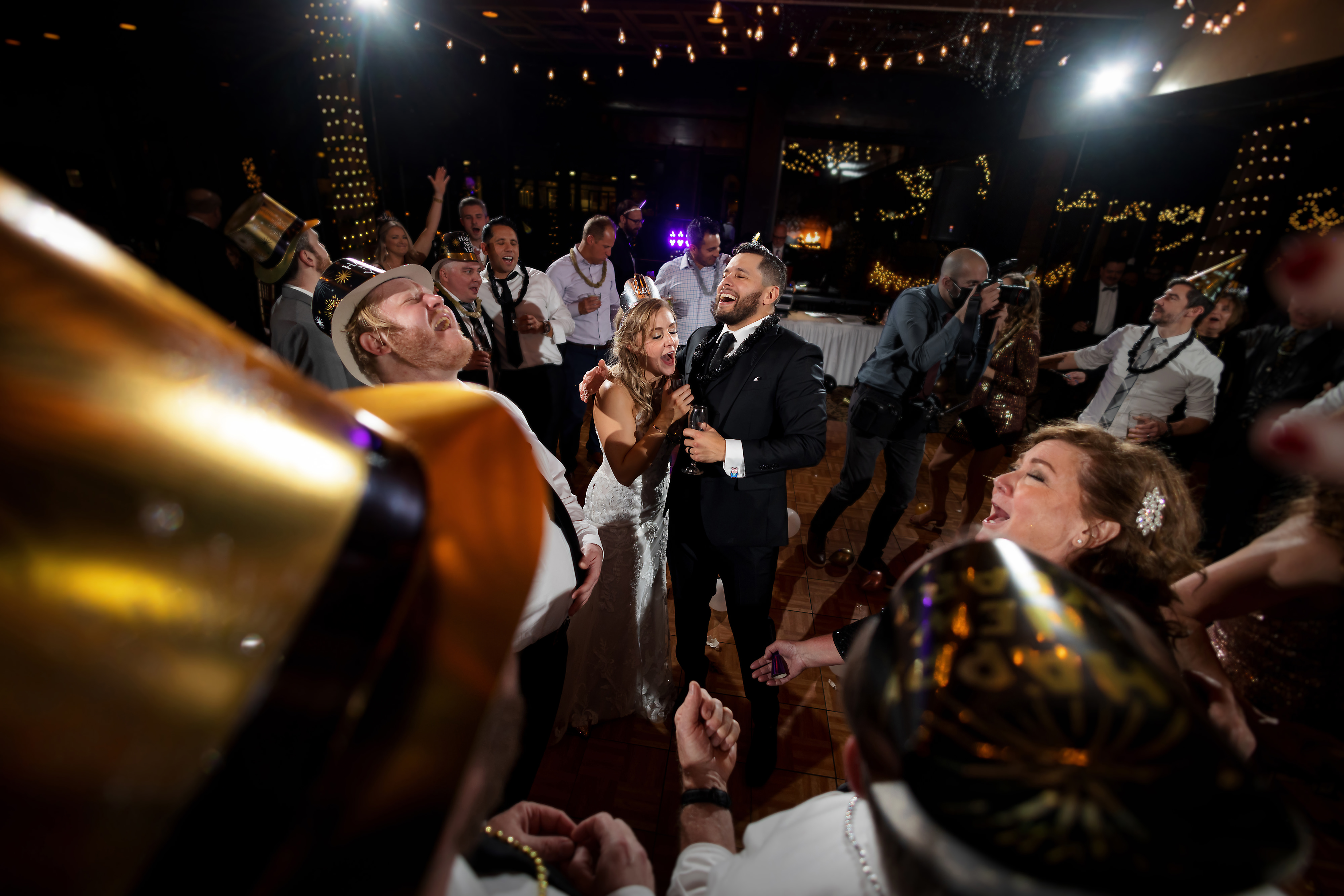 Wedding guests dance during winter wedding at Two Brothers Roundhouse Brewery in Aurora, Illinois