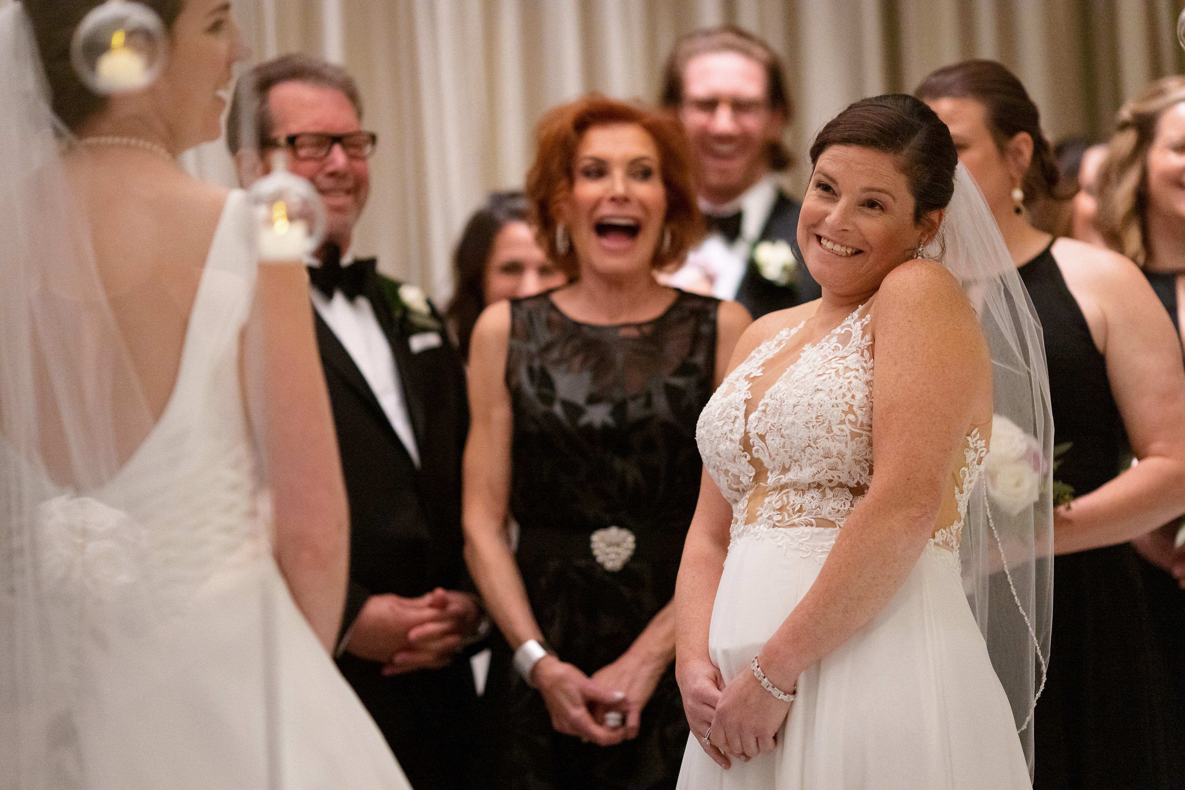 Brides laugh during wedding ceremony at The Langham Hotel in downtown Chicago