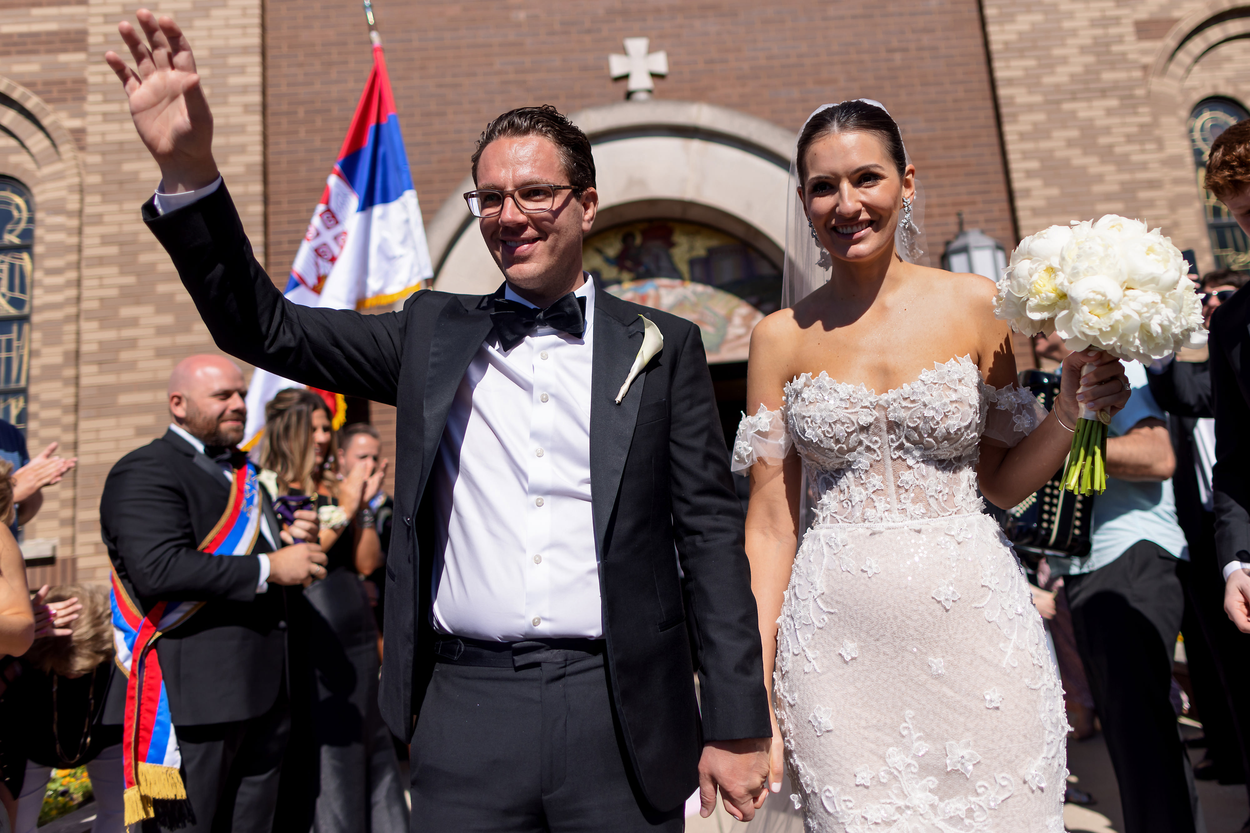 Bride and groom walk outside after wedding ceremony at George Serbian Orthodox Church