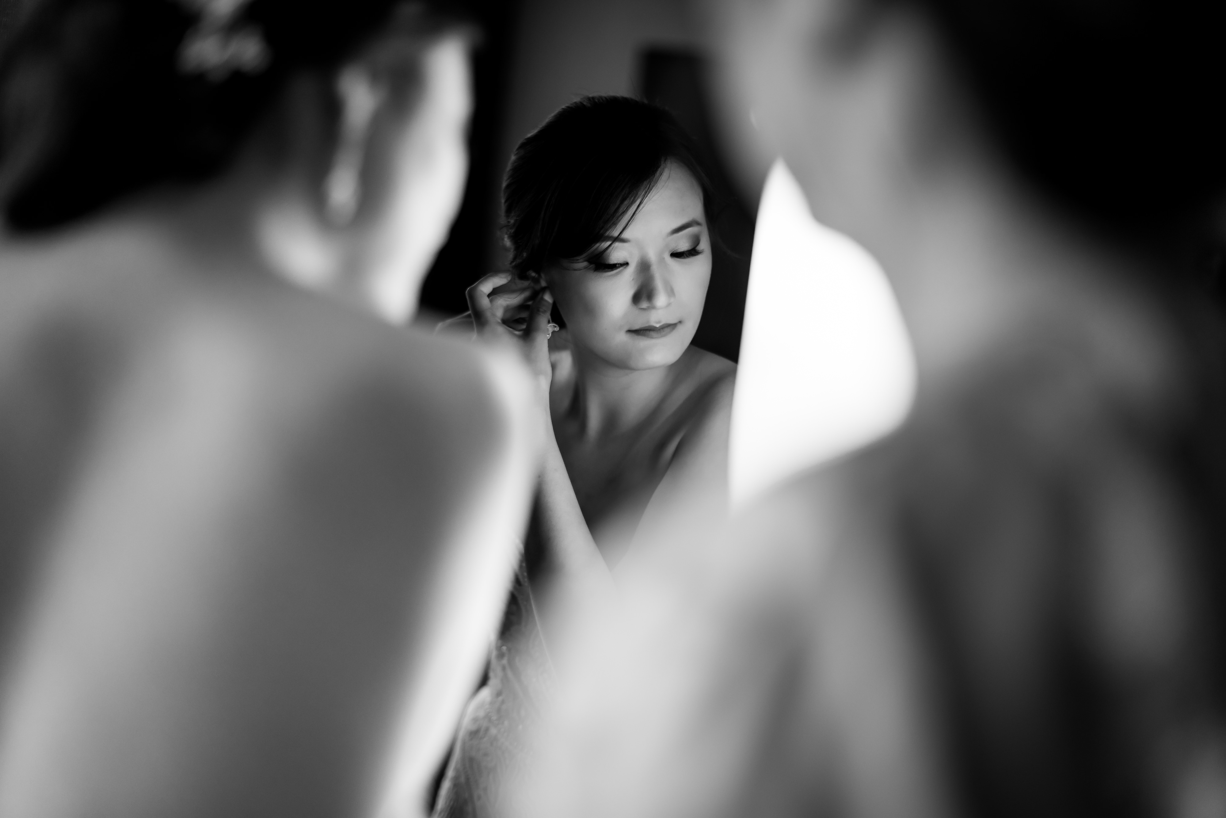 Bride puts on earrings while getting ready for her wedding at Loews Hotel in downtown Chicago