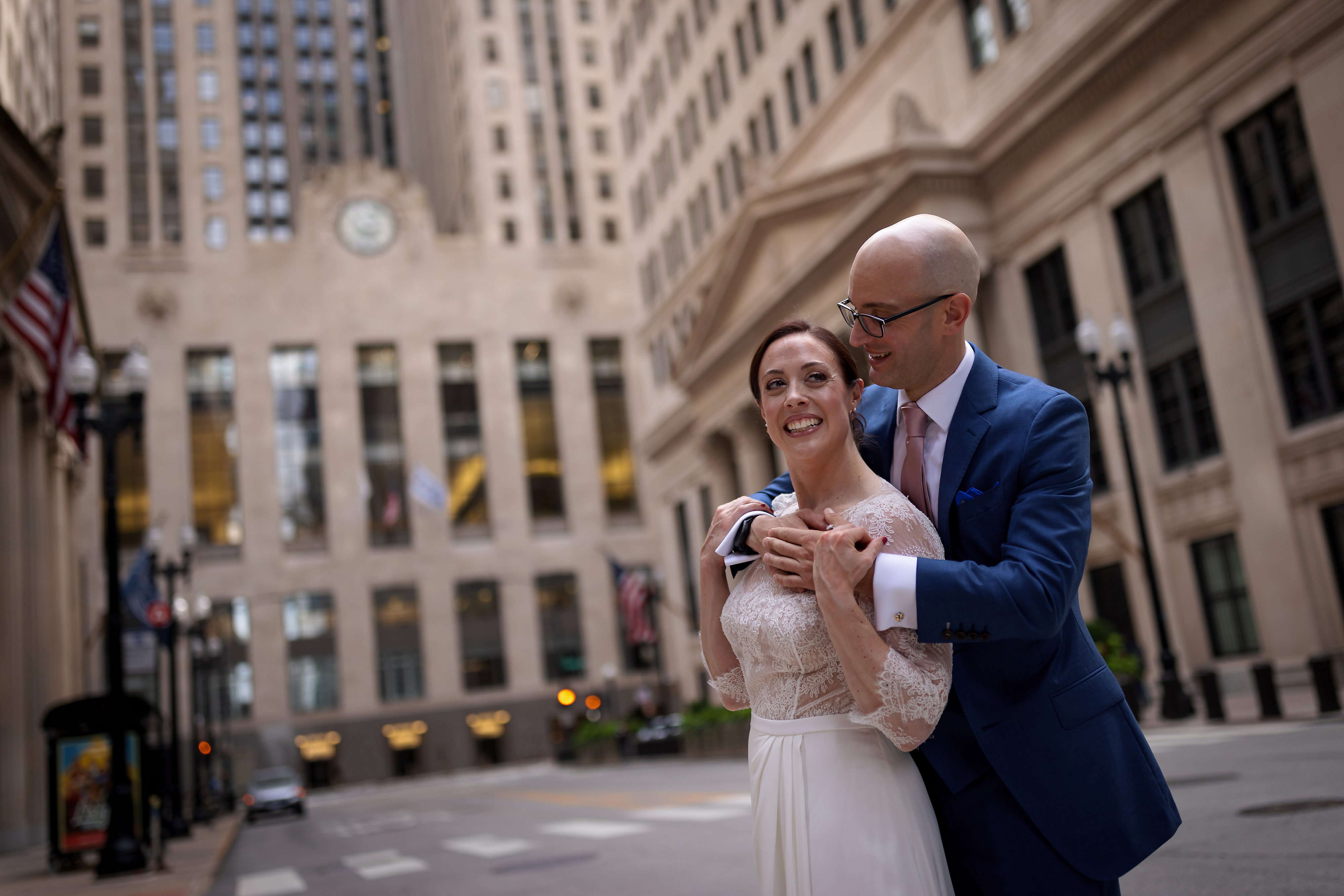 Bride and groom pose for portraits near the Board of Trade Building in downtown Chicago