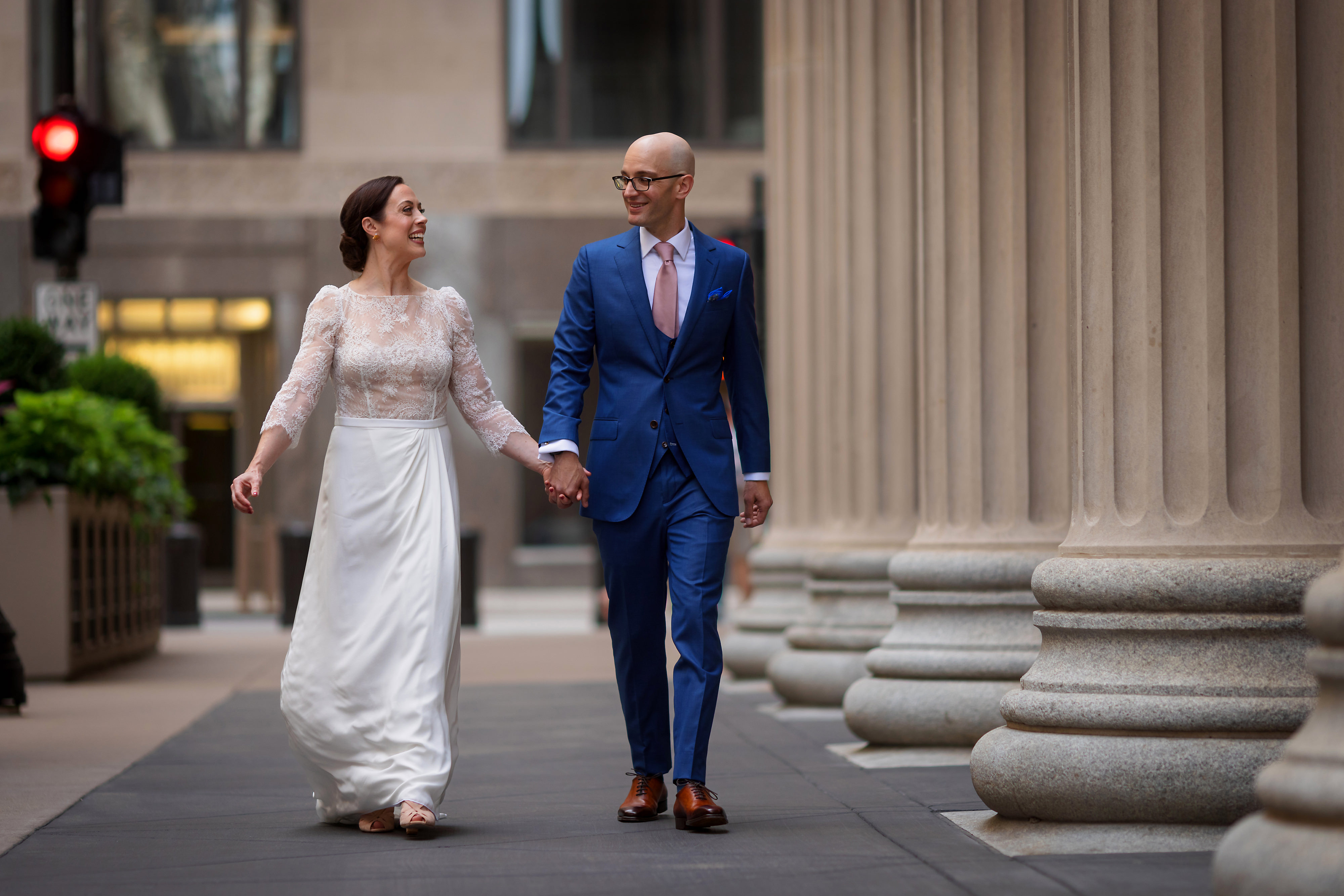 Bride and groom pose for portraits near the Board of Trade Building in downtown Chicago