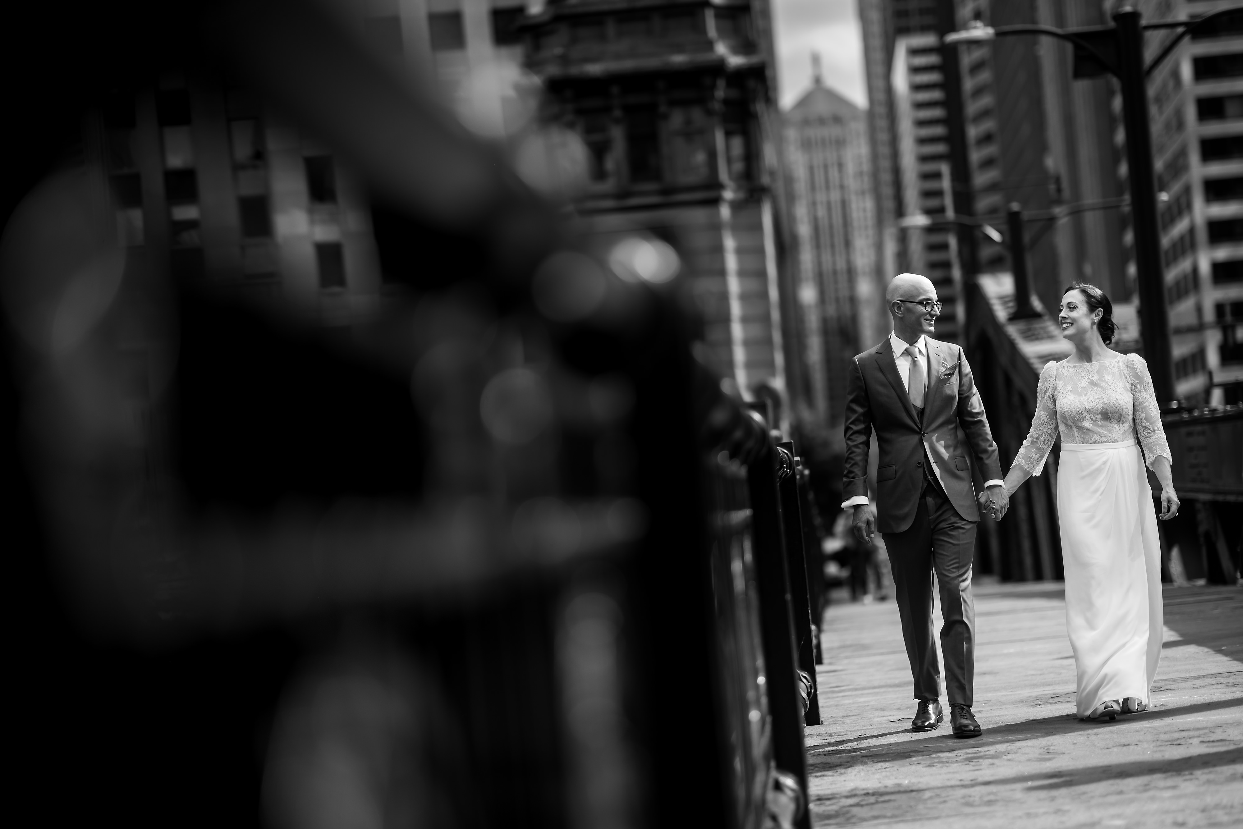 Bride and groom pose for portraits near LaSalle Street Bridge in downtown Chicago
