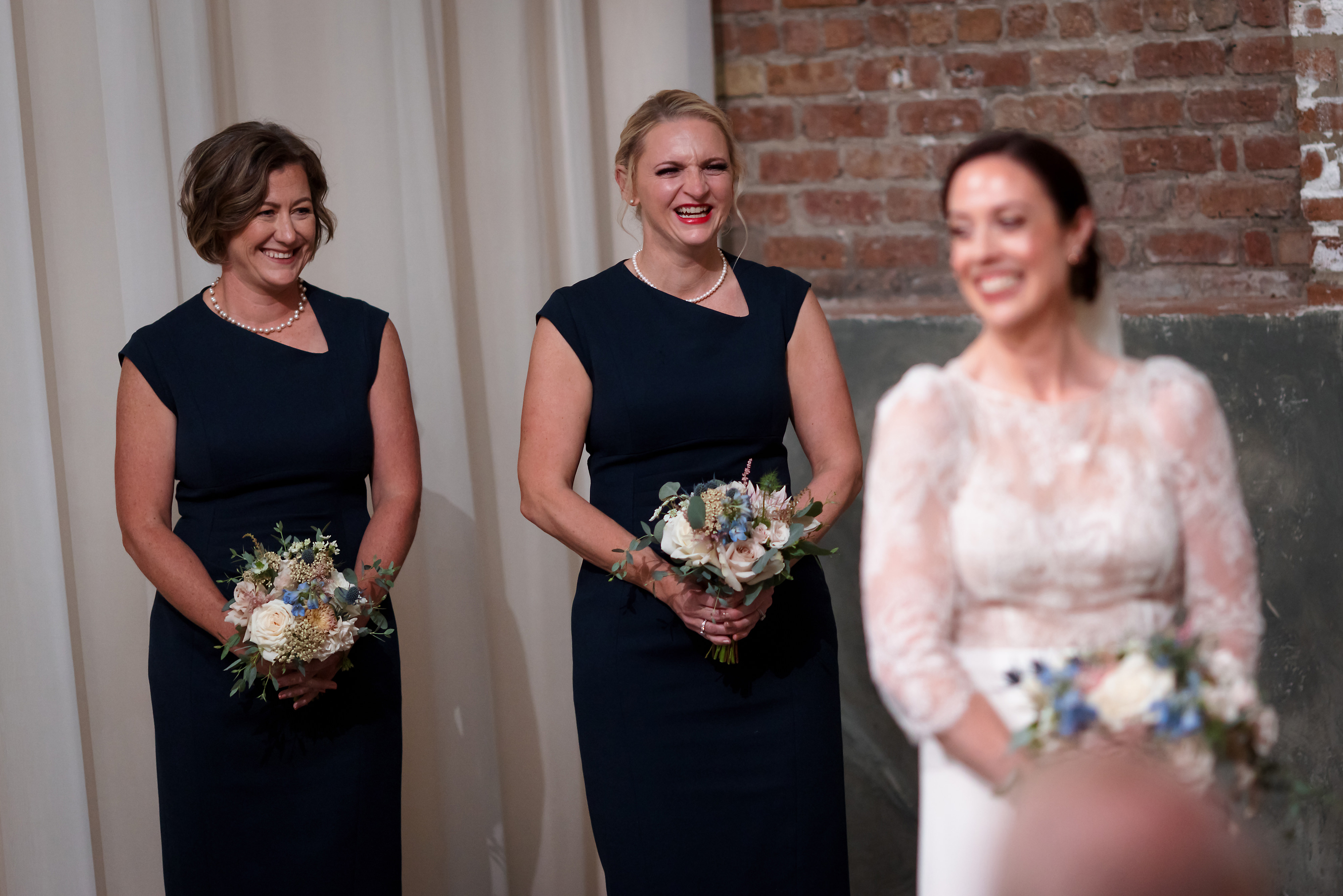 Bridesmaids laugh during wedding ceremony at The Fairlie