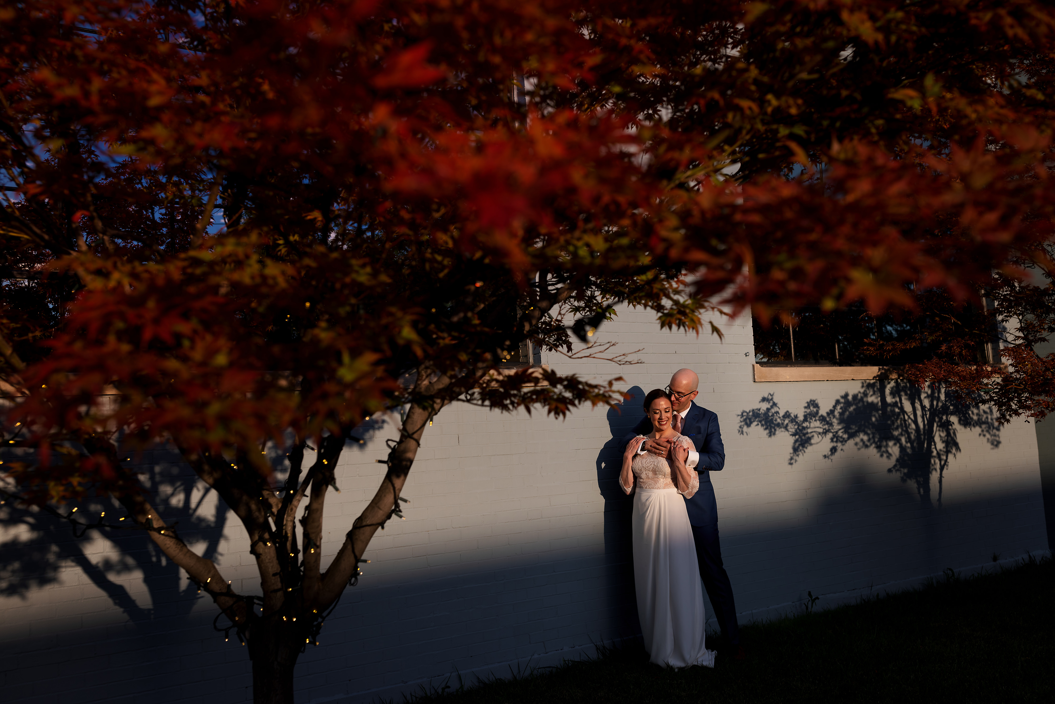 Bride and groom pose for portraits outside The Fairlie wedding venue