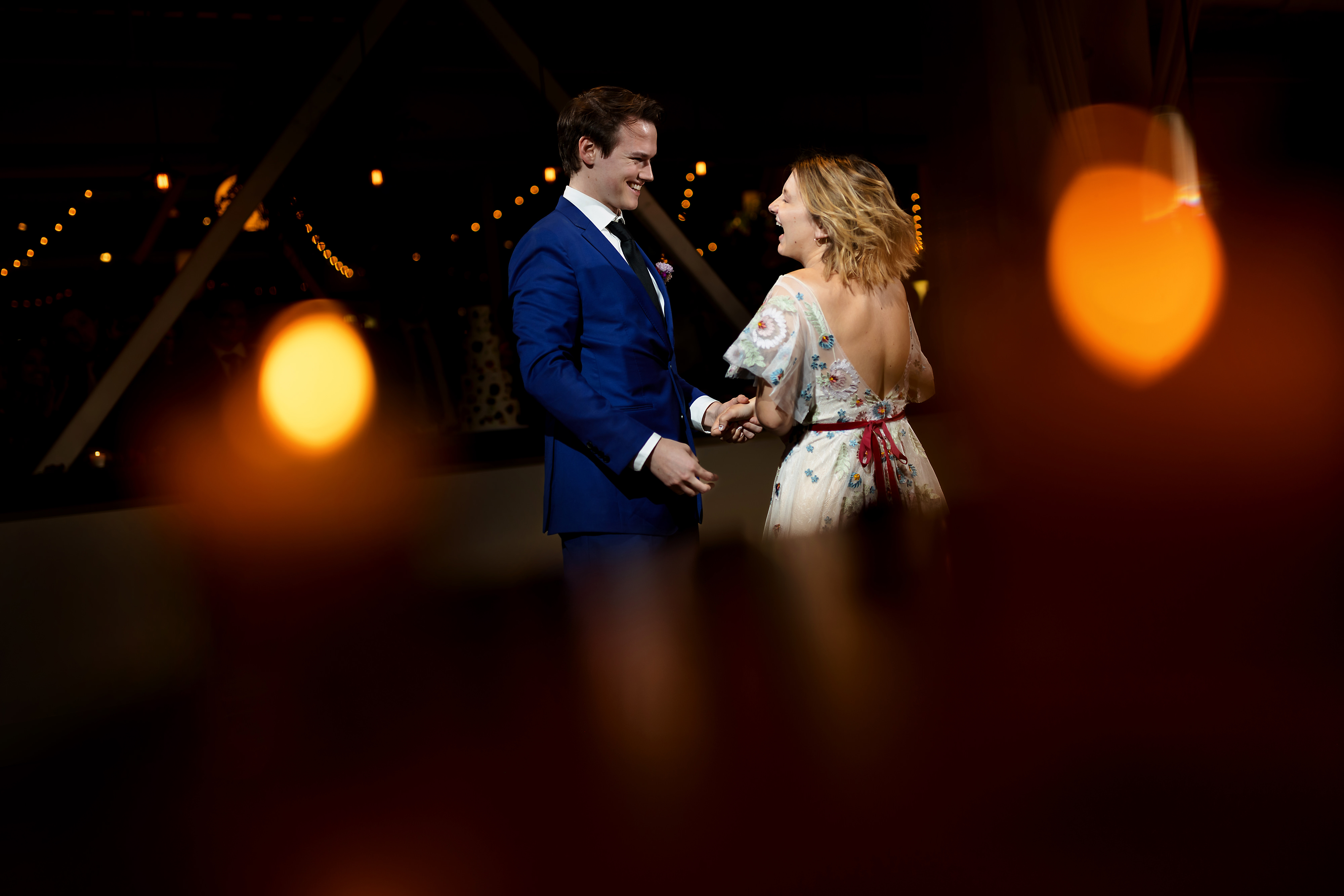 Bride and groom first dance with candles in the forground during wedding reception at Greenhouse Loft in Chicago