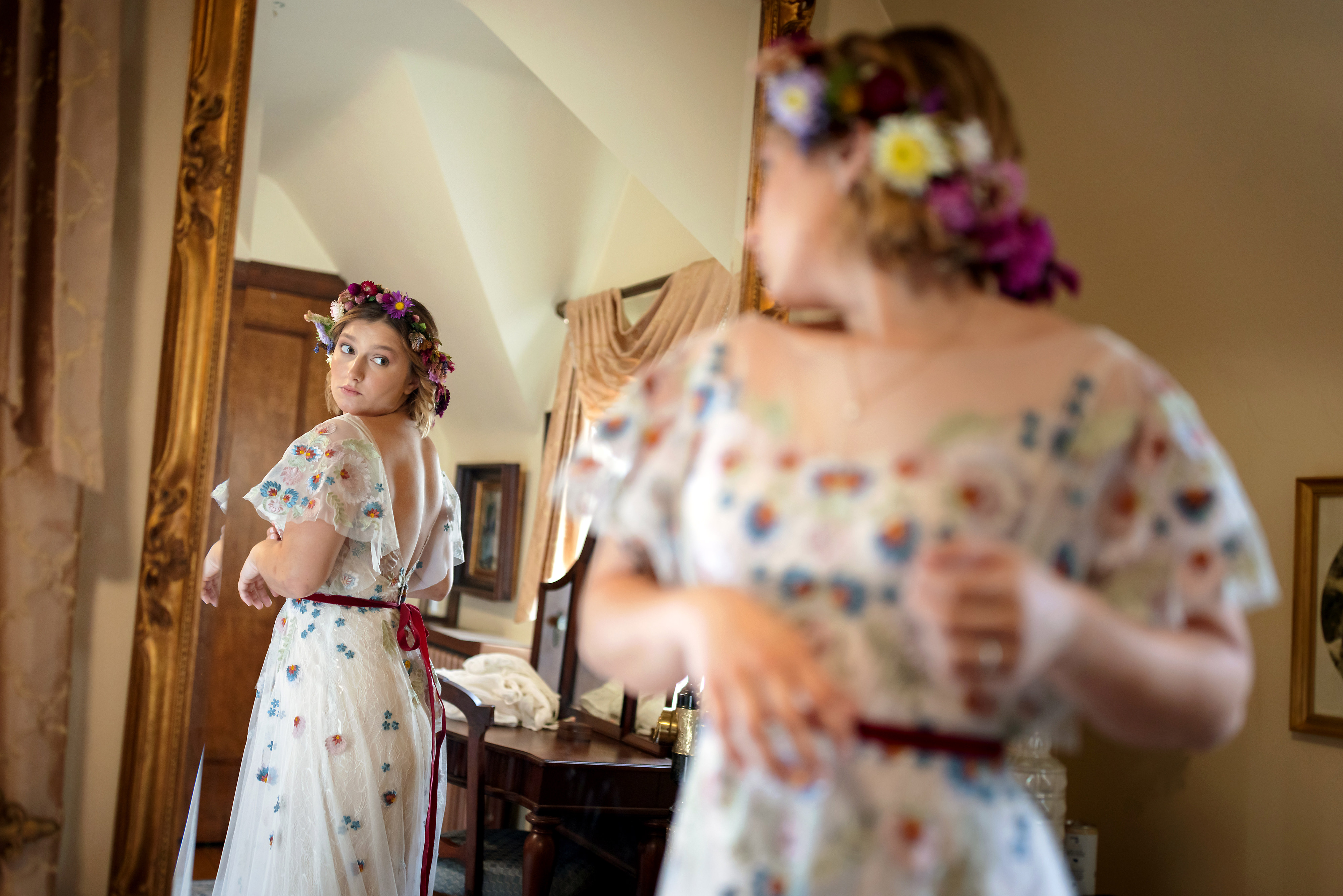 bride looks in mirror while getting ready for wedding at The Grove Redfield Estate in Glenview