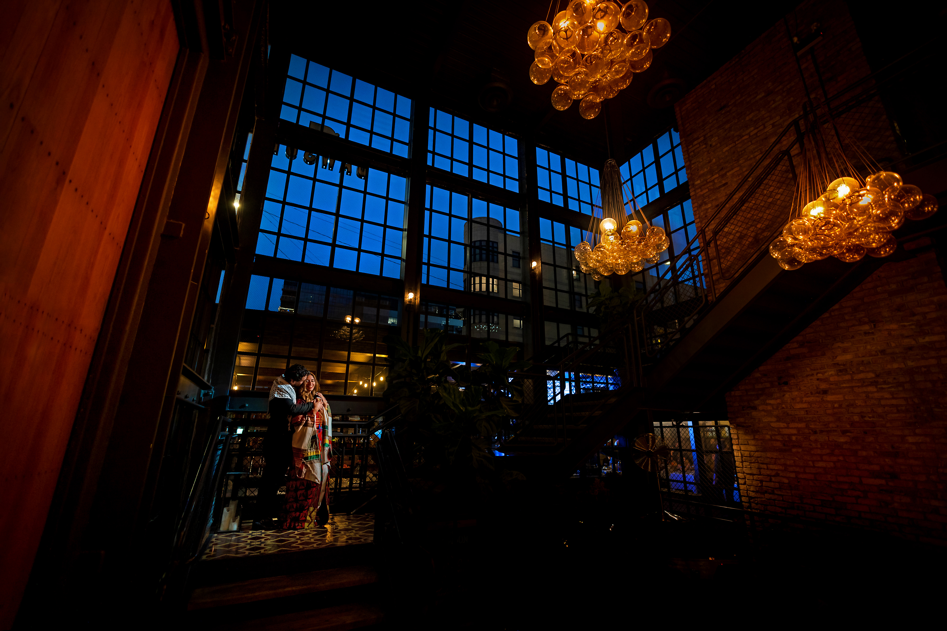 wide angle view of wedding couple on the stairs during wedding reception at The Dawson restaurant in downtown Chicago