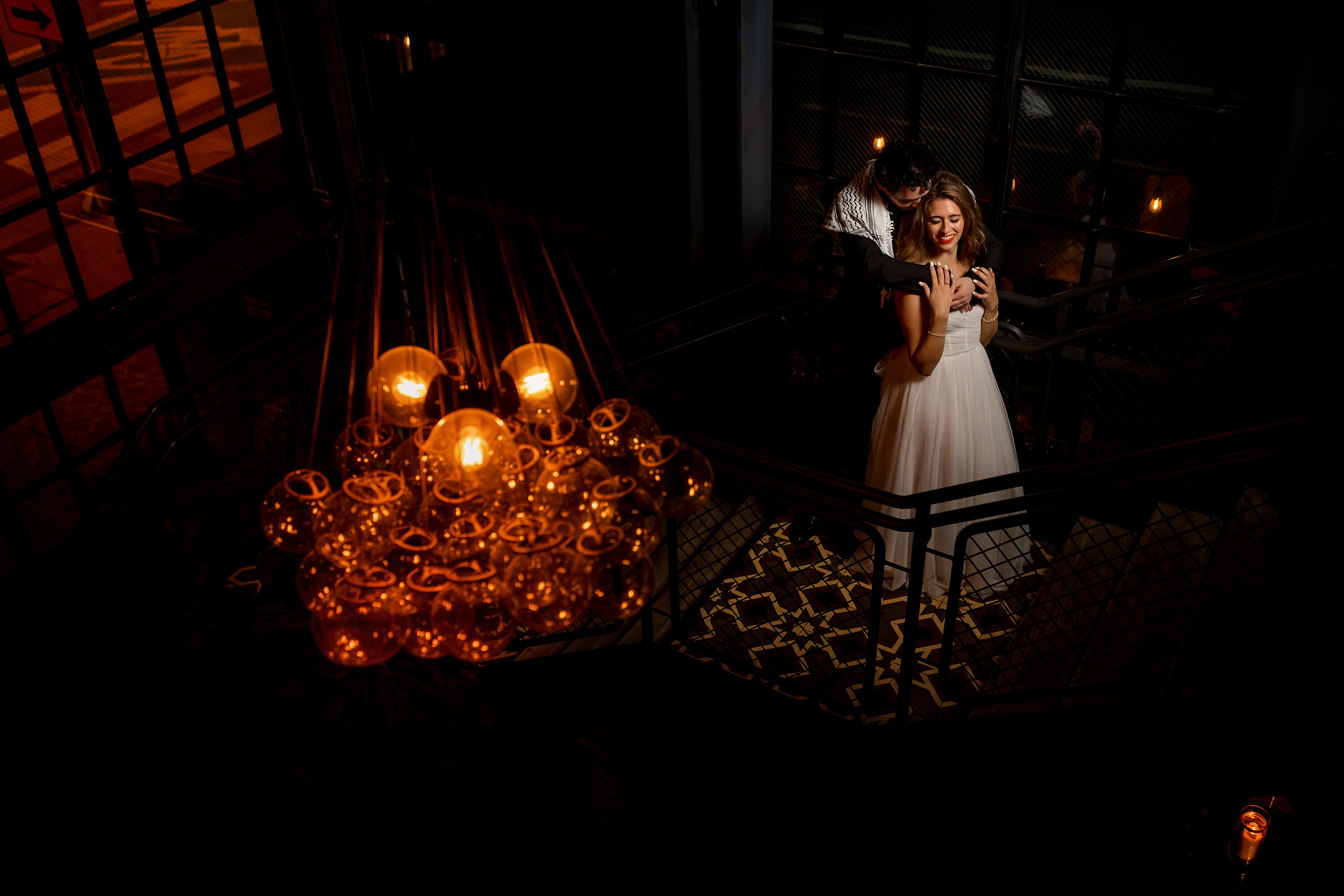 Couple poses for photo on the staircase during wedding reception at The Dawson restaurant in downtown Chicago