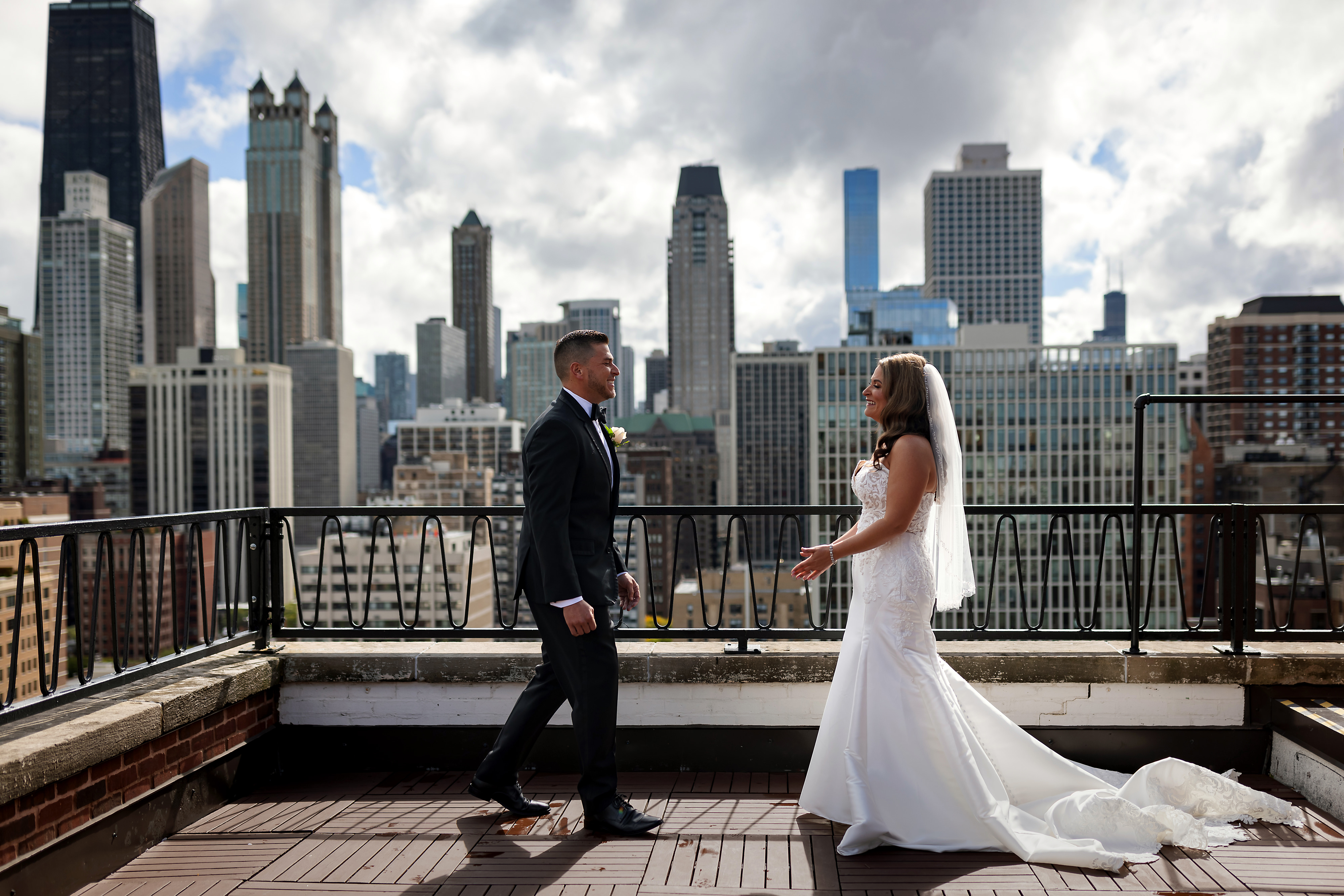 First look with bride and groom on wedding day at rooftop patio at Ambassador Hotel Chicago with skyline in the background.