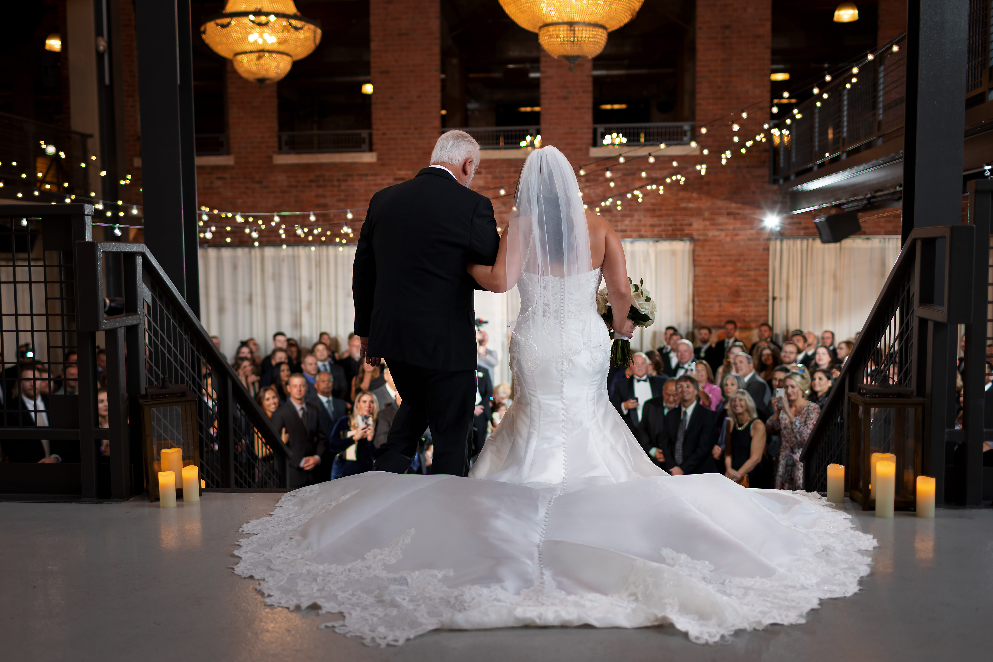 Bride walk down the aisle with father during wedding ceremony at Artifact Events in Chicago's Ravenswood neighborhood.