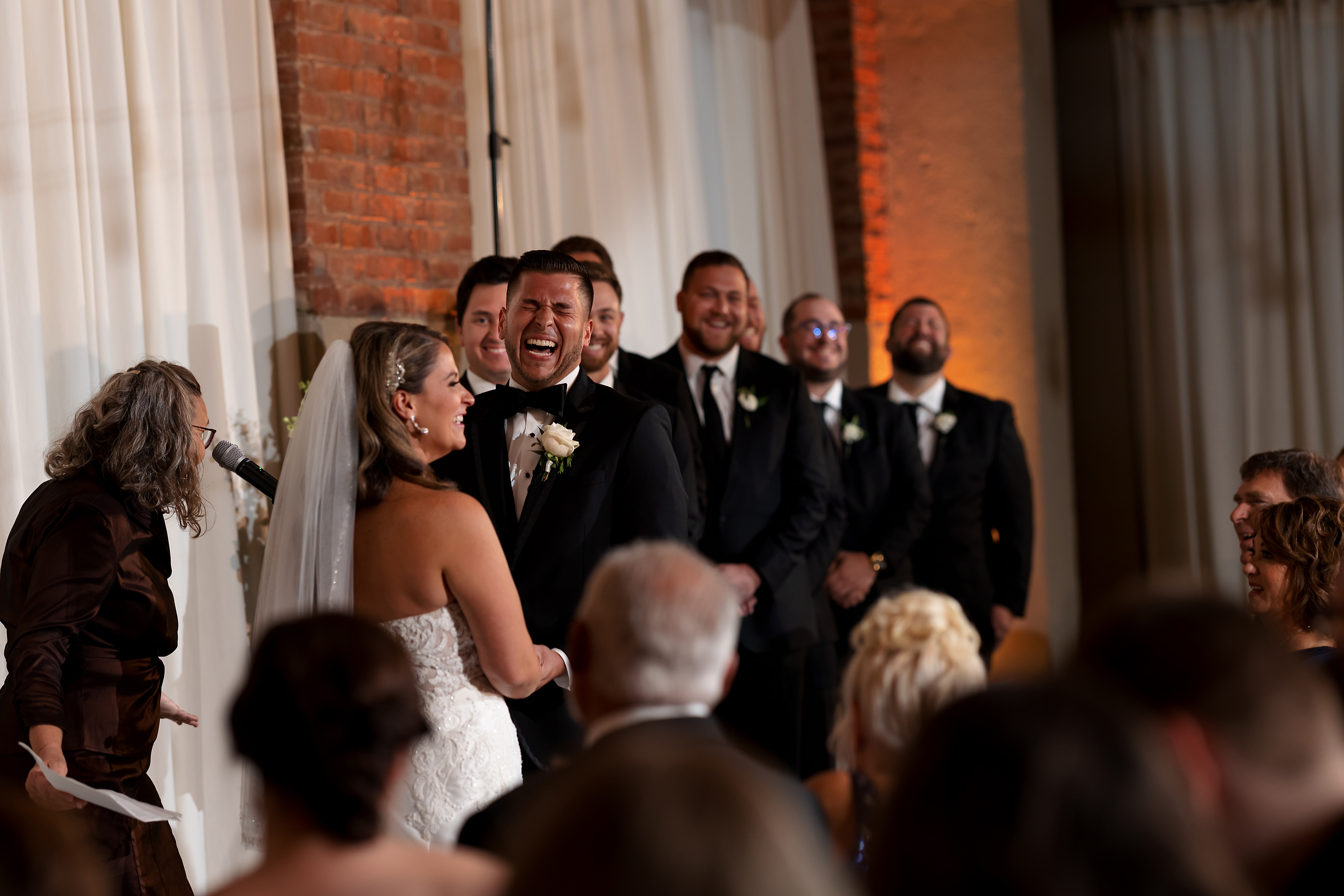 Groom laughs during wedding ceremony at Artifact Events in Chicago's Ravenswood neighborhood.