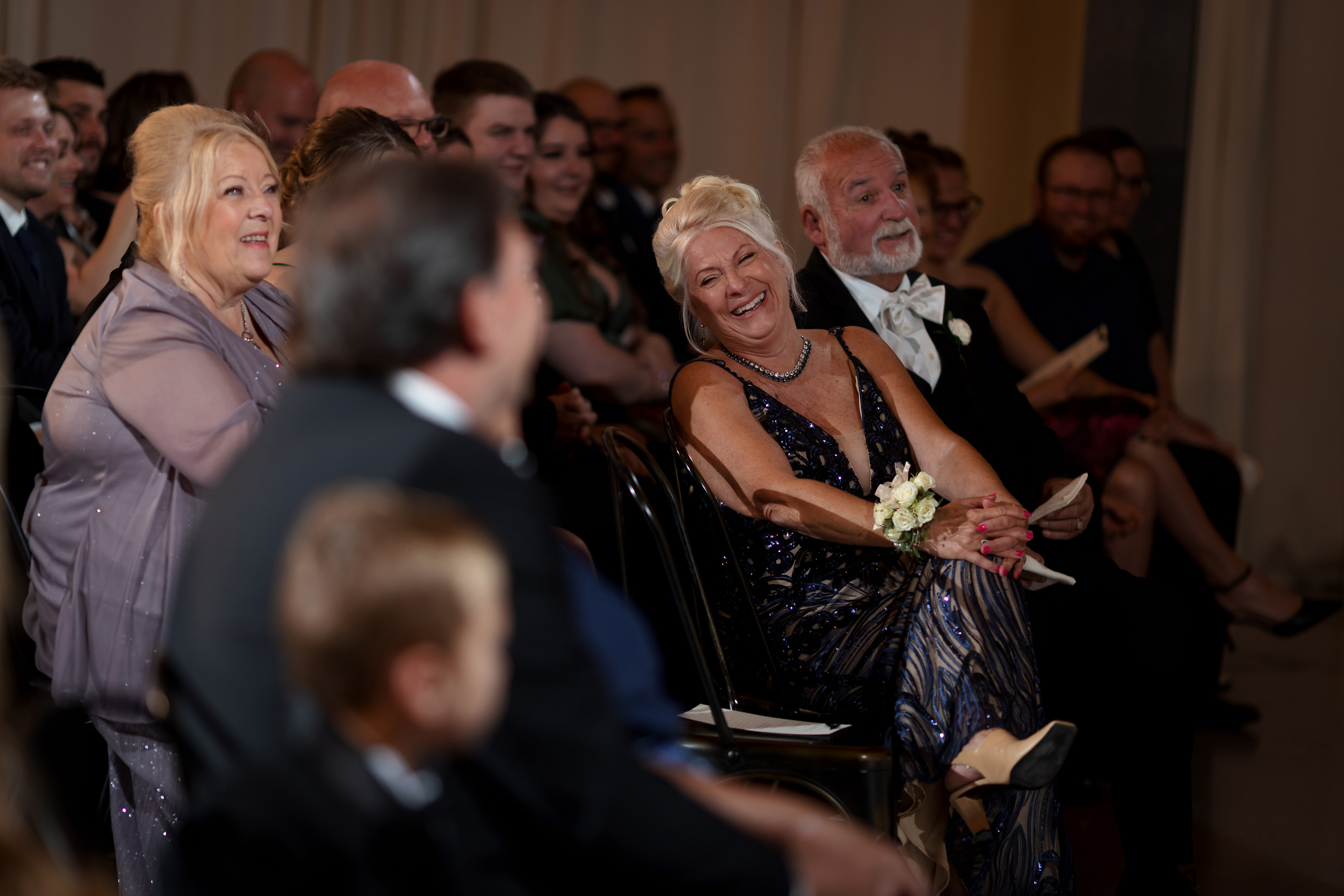 Parents and guest laugh during wedding ceremony at Artifact Events in Chicago's Ravenswood neighborhood.