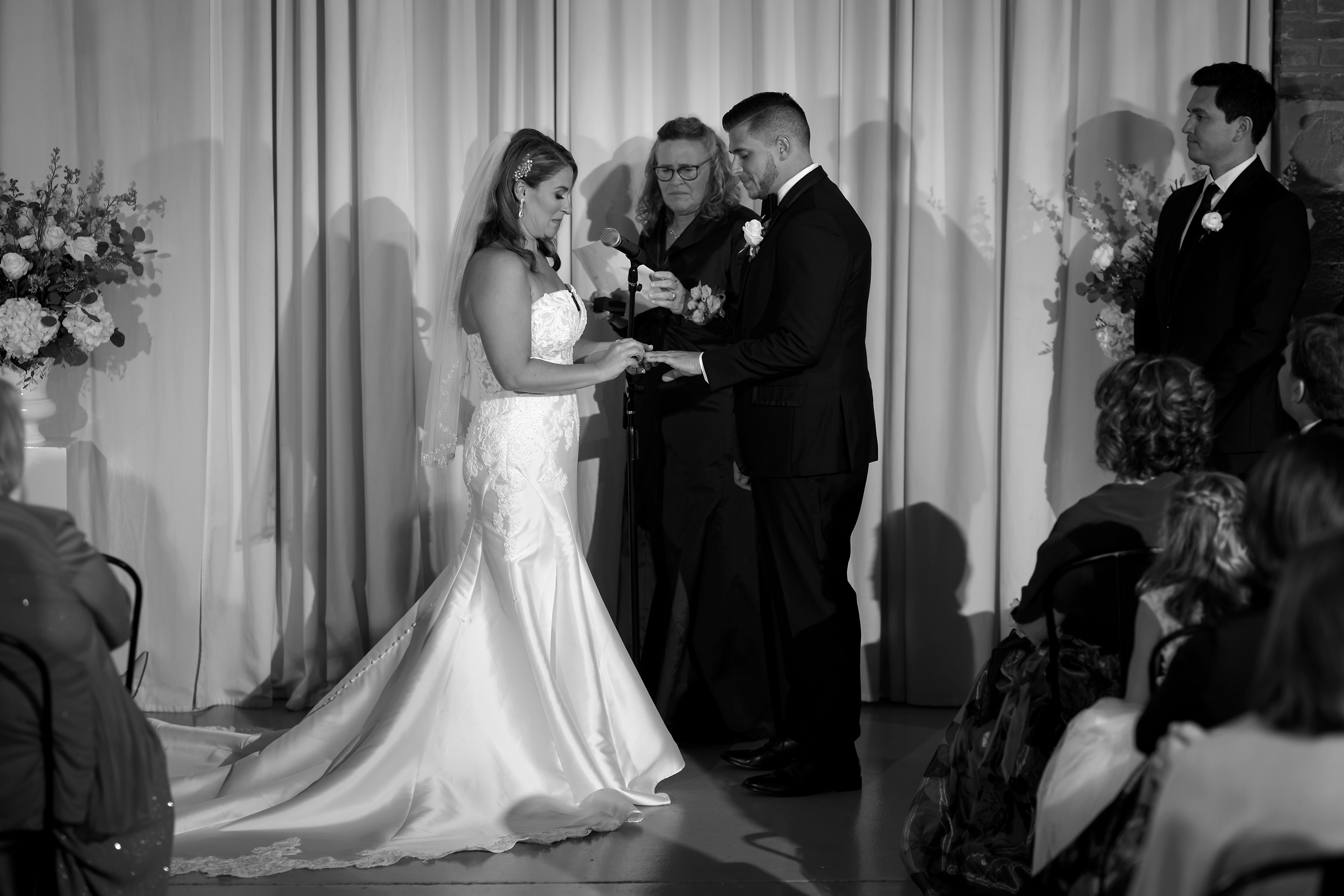 Bride and groom exchange rings during wedding ceremony at Artifact Events in Chicago's Ravenswood neighborhood.