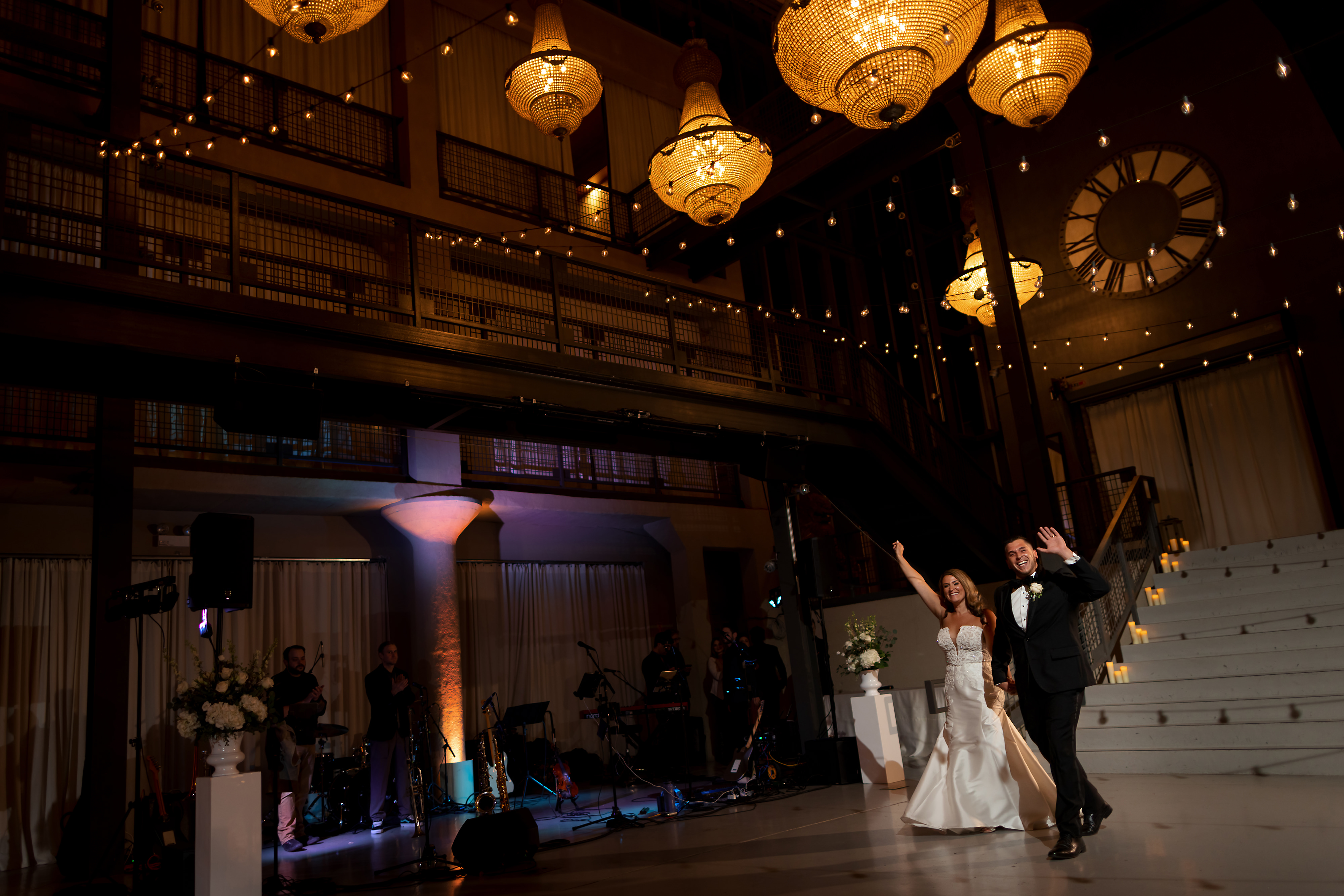 Bride and groom walk into reception on the first floor during Artifact Events wedding in Chicago