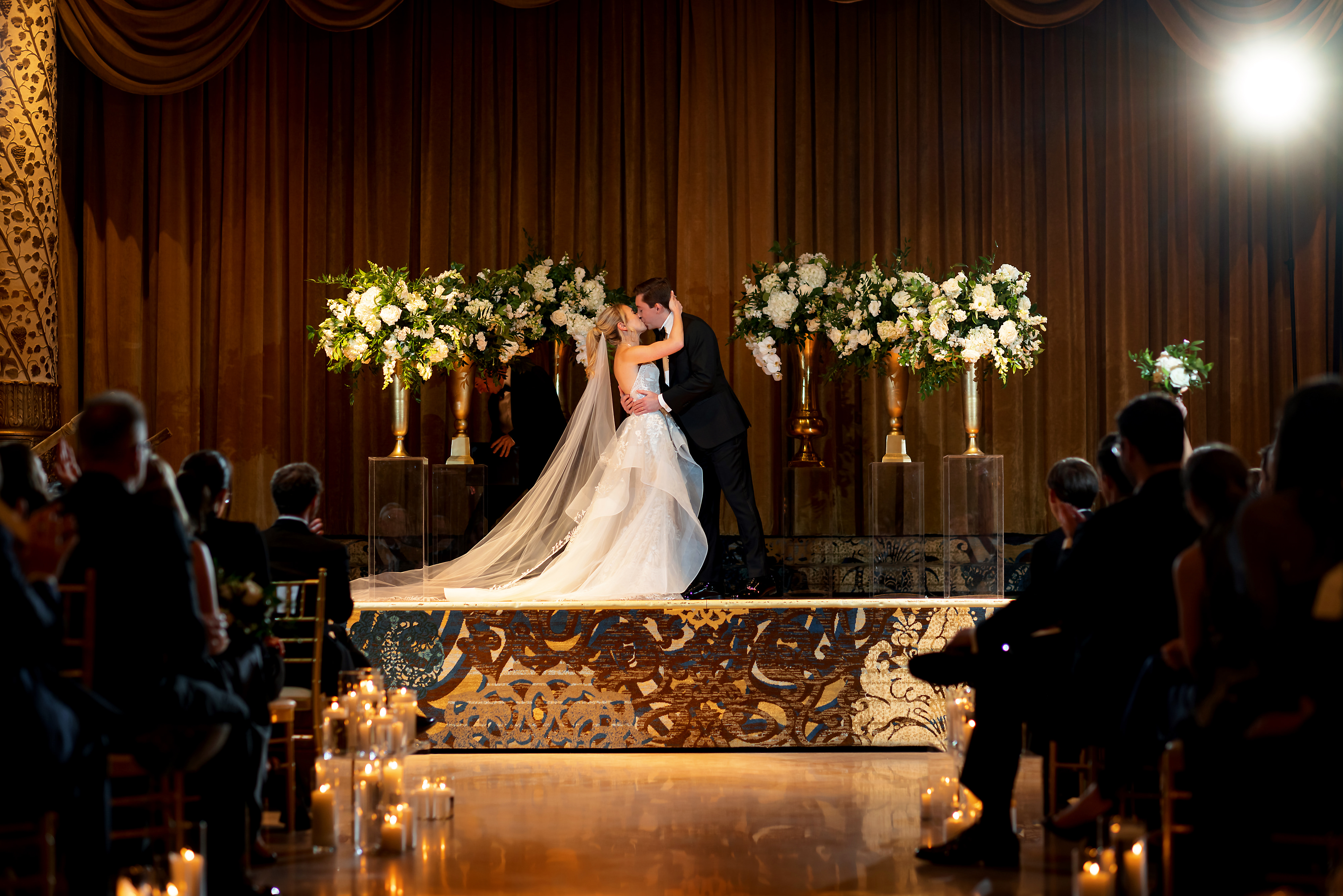 Bride and Groom kiss at the end of wedding ceremony in the Grand Ballroom at The Drake Hotel in Chicago