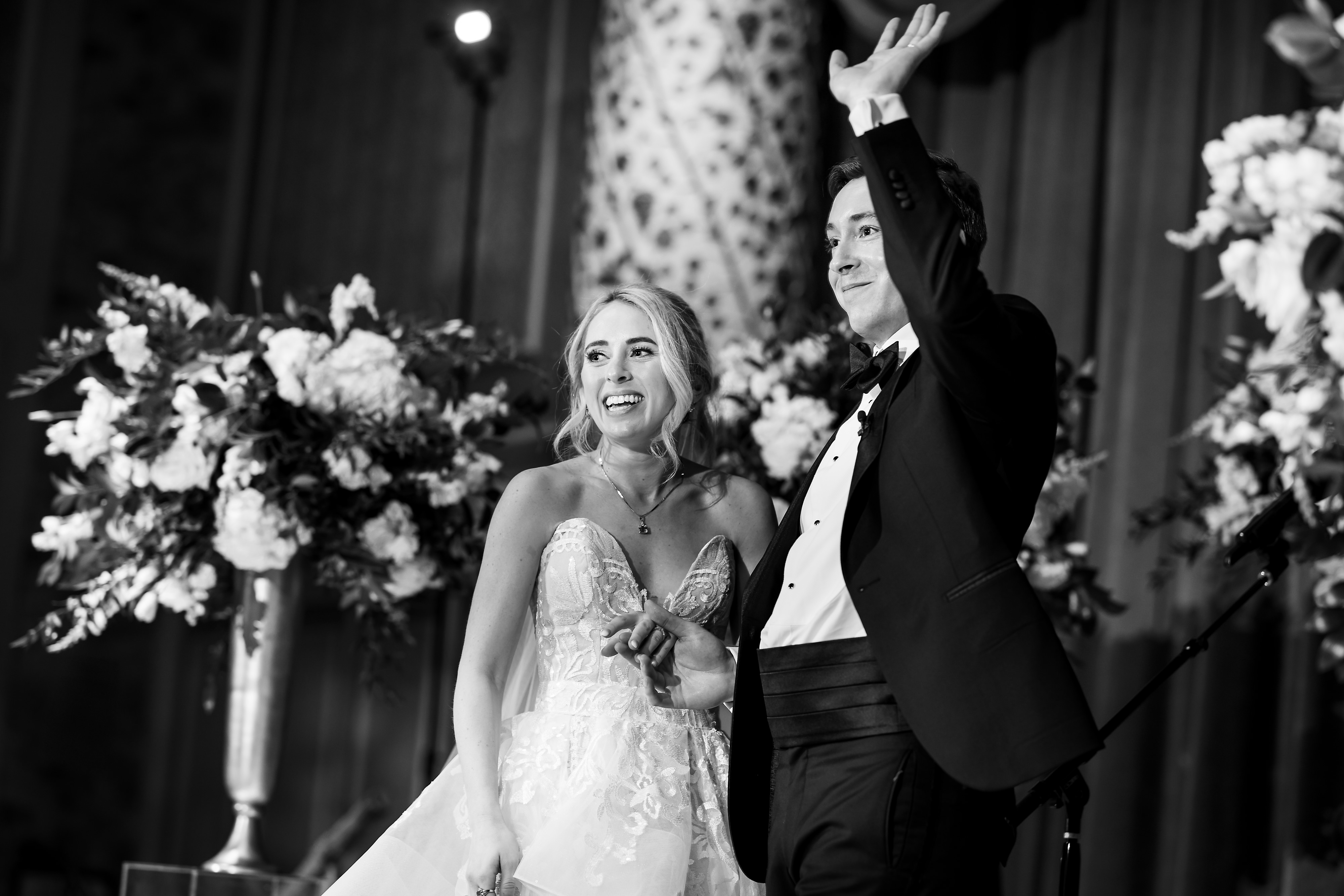 Bride and Groom wave to guests during wedding ceremony in the Grand Ballroom at The Drake Hotel in Chicago