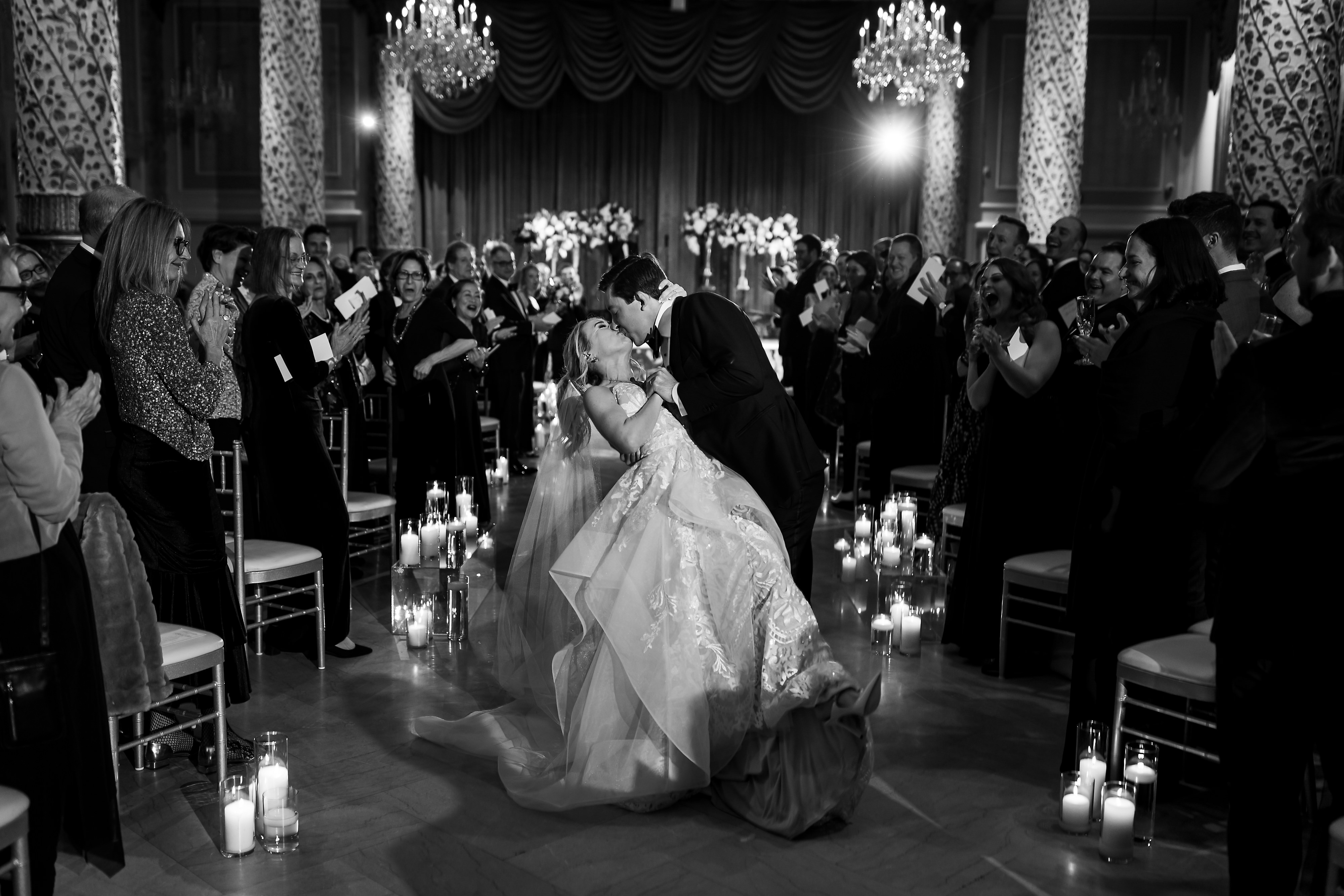 Bride and Groom kiss while walking down the aisle after wedding ceremony in the Grand Ballroom at The Drake Hotel in Chicago