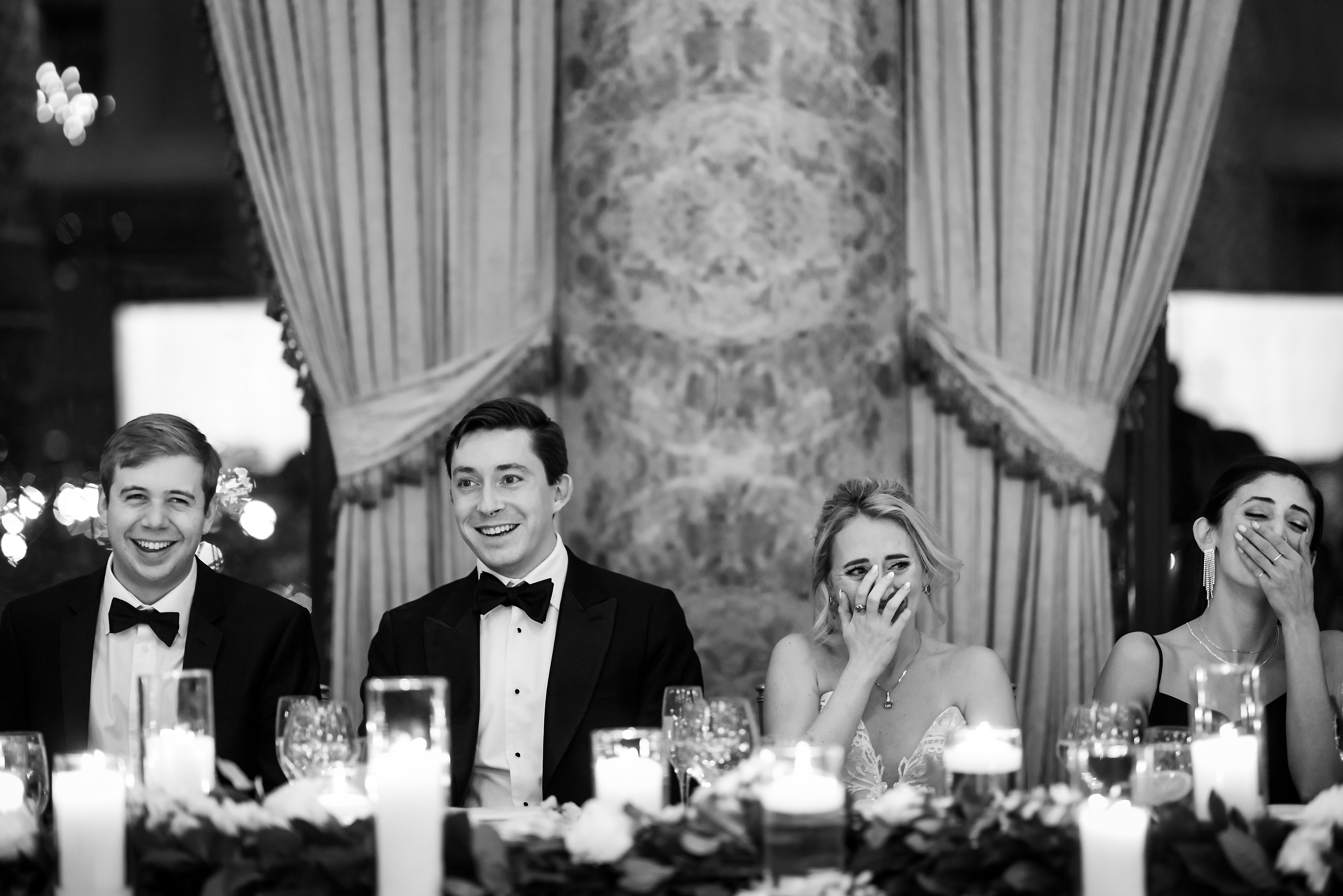 Wedding party reacts to toast during wedding reception in the Grand Ballroom at The Drake Hotel in Chicago
