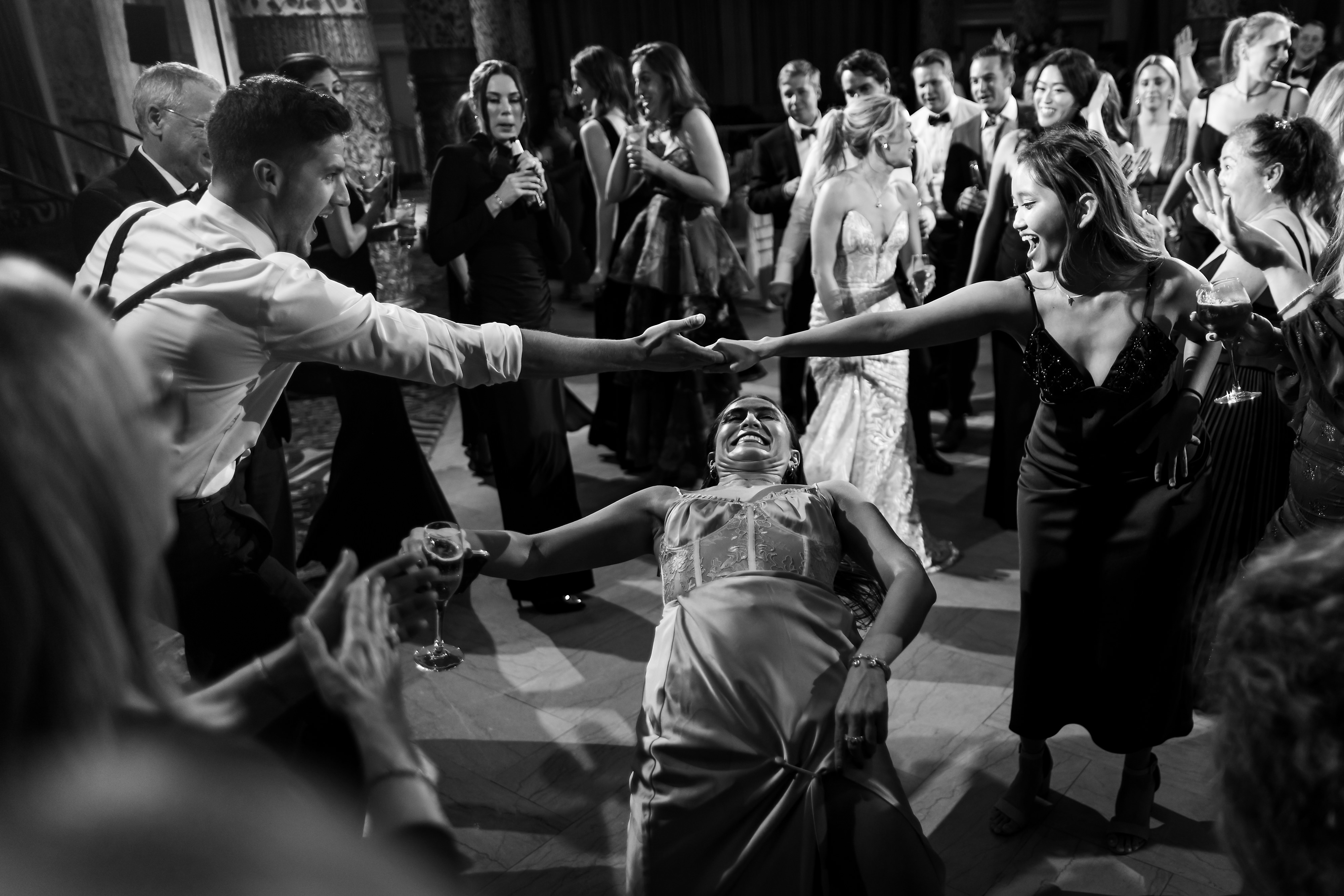 Wedding guests dance during wedding reception in the Grand Ballroom at The Drake Hotel in Chicago