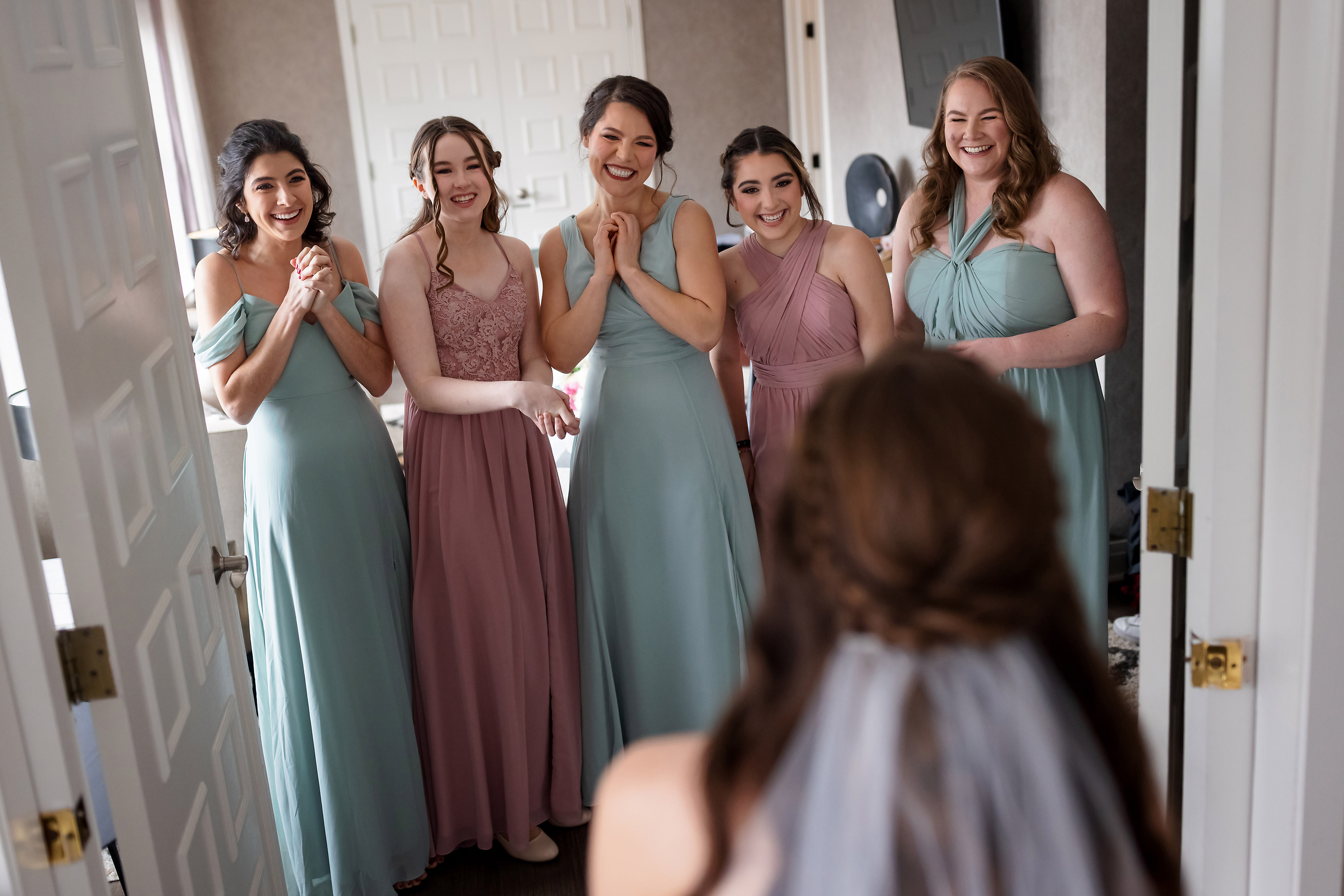 Bridesmaids react to seeing bride in wedding dress before her Lincoln Park Chicago wedding