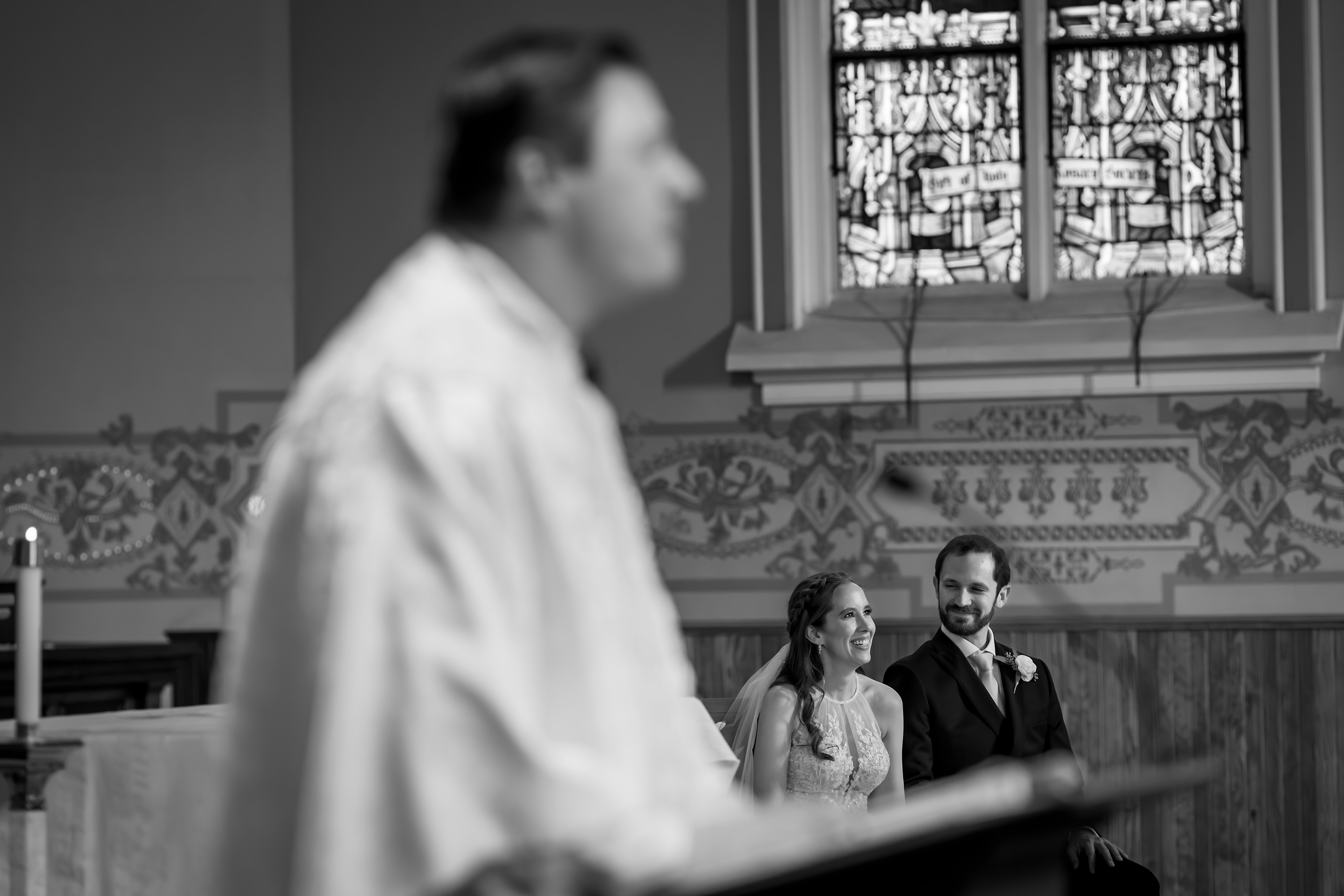 Bride and groom smile at each other during wedding ceremony at  St. Joseph Catholic Church in Chicago