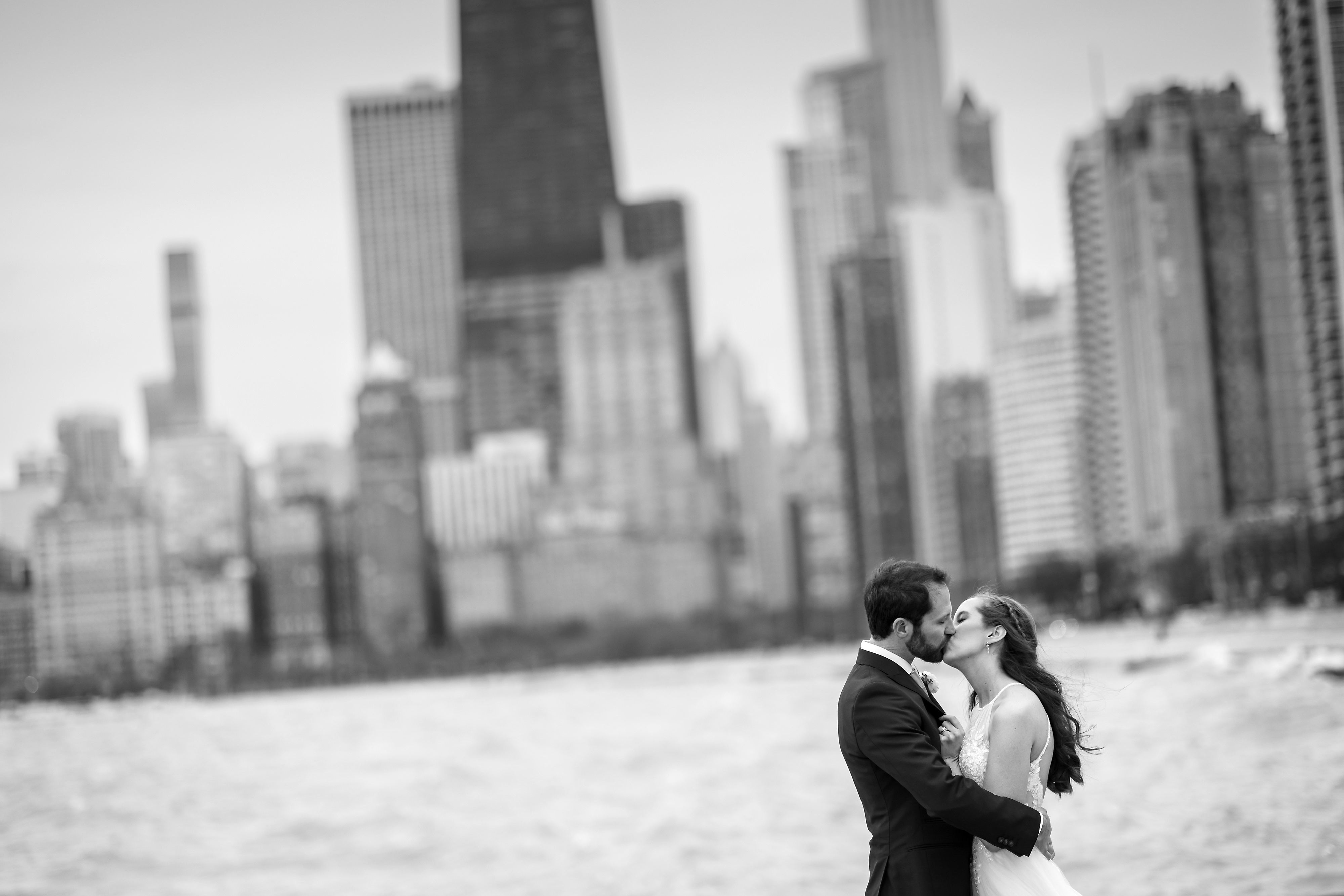 Bride and groom pose for portrait at North Ave. Beach in Chicago