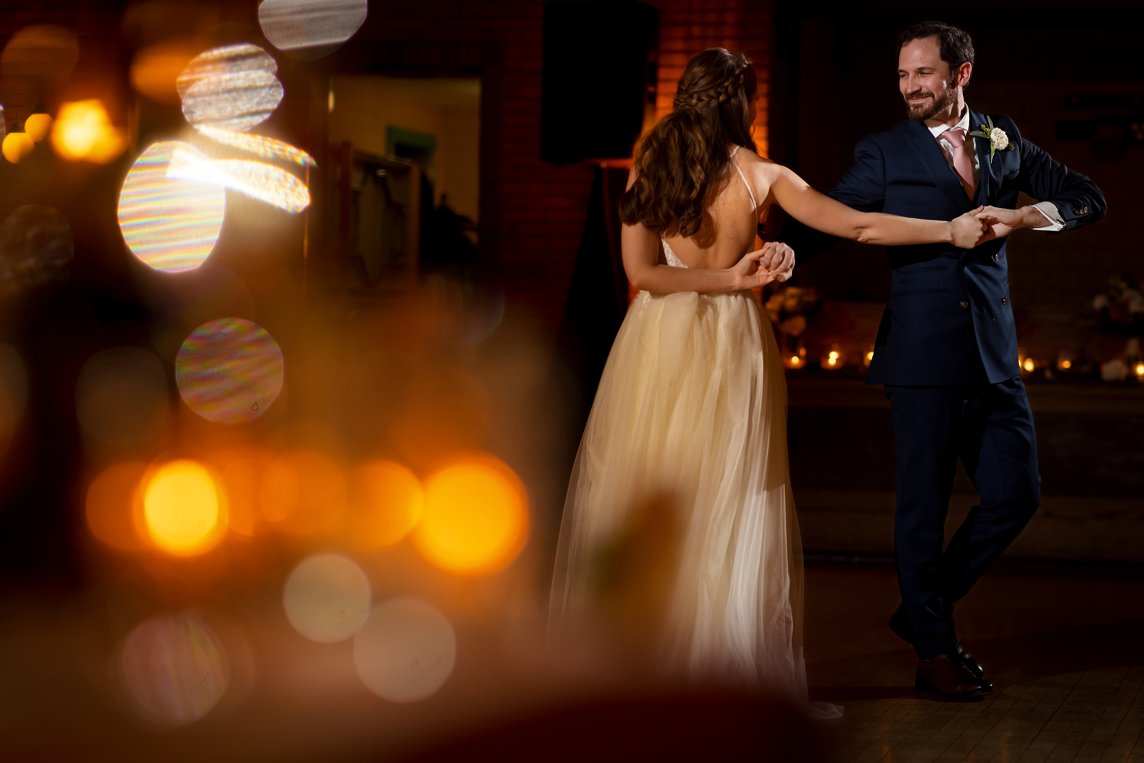Couple shares their choreographed first dance during wedding reception at Cafe Brauer in Chicago's Lincoln Park neighborhood