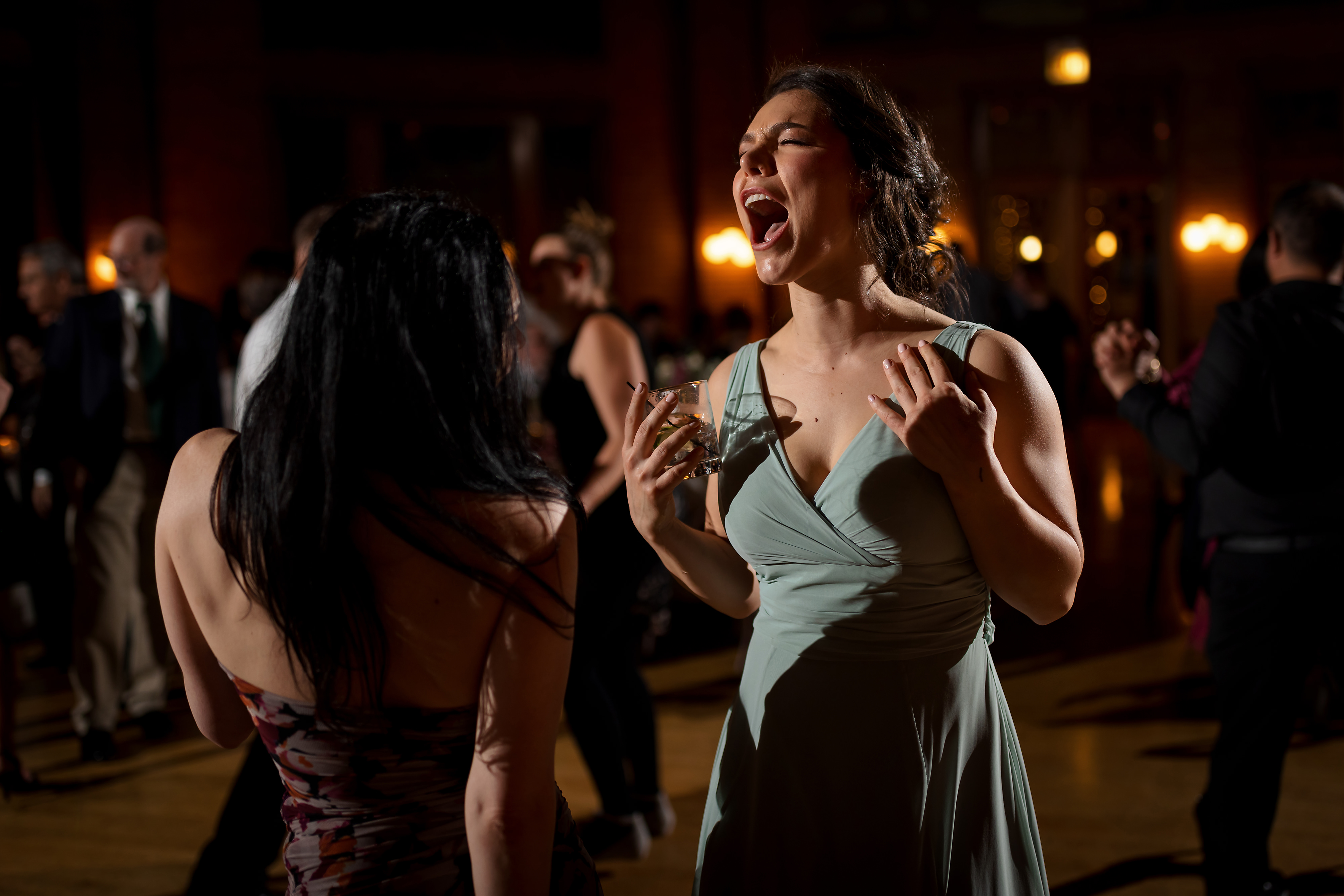 wedding guests dance during wedding reception at Cafe Brauer in Chicago's Lincoln Park neighborhood