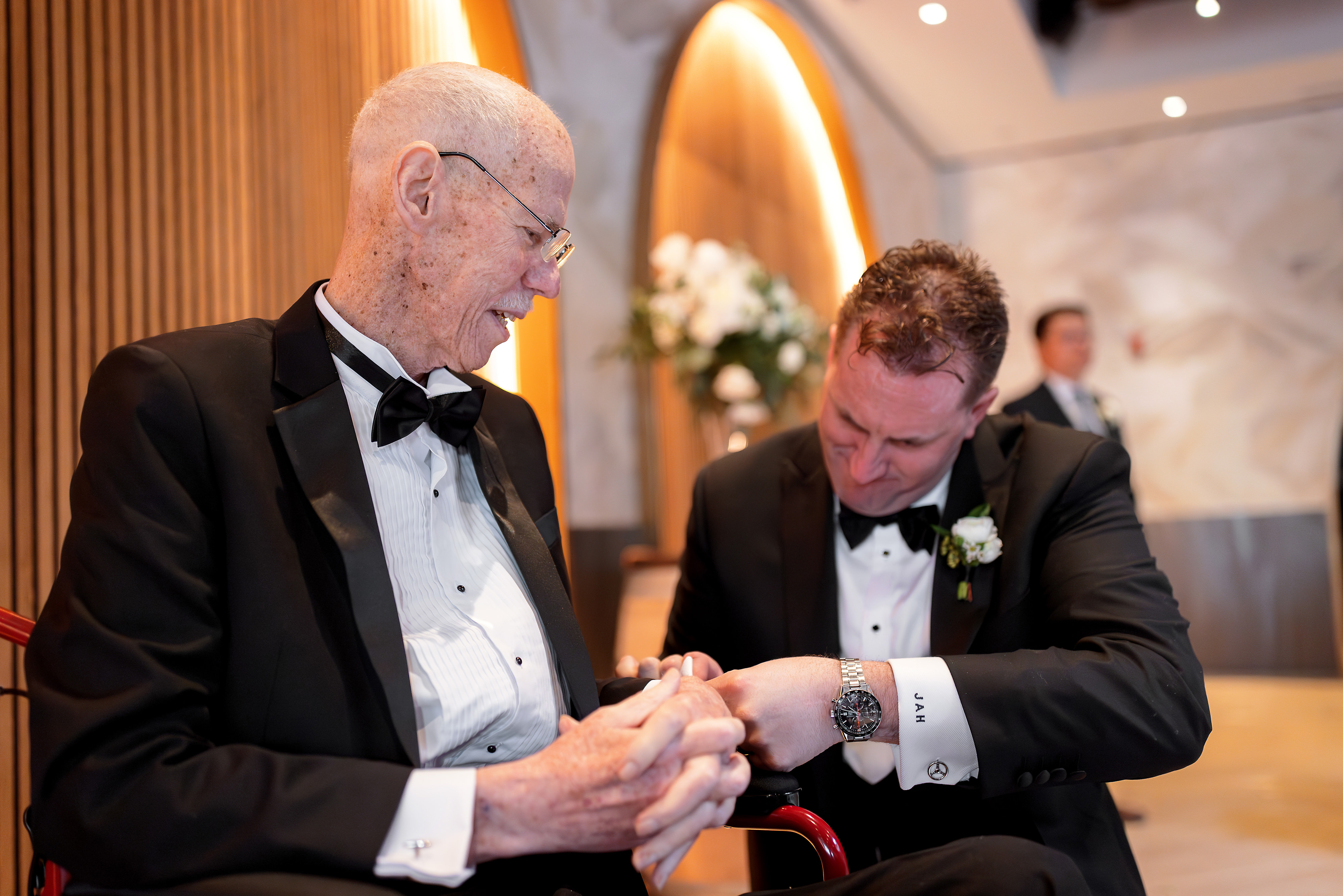Groom helps father-in-law with cuff link before wedding ceremony at Chicago Winery