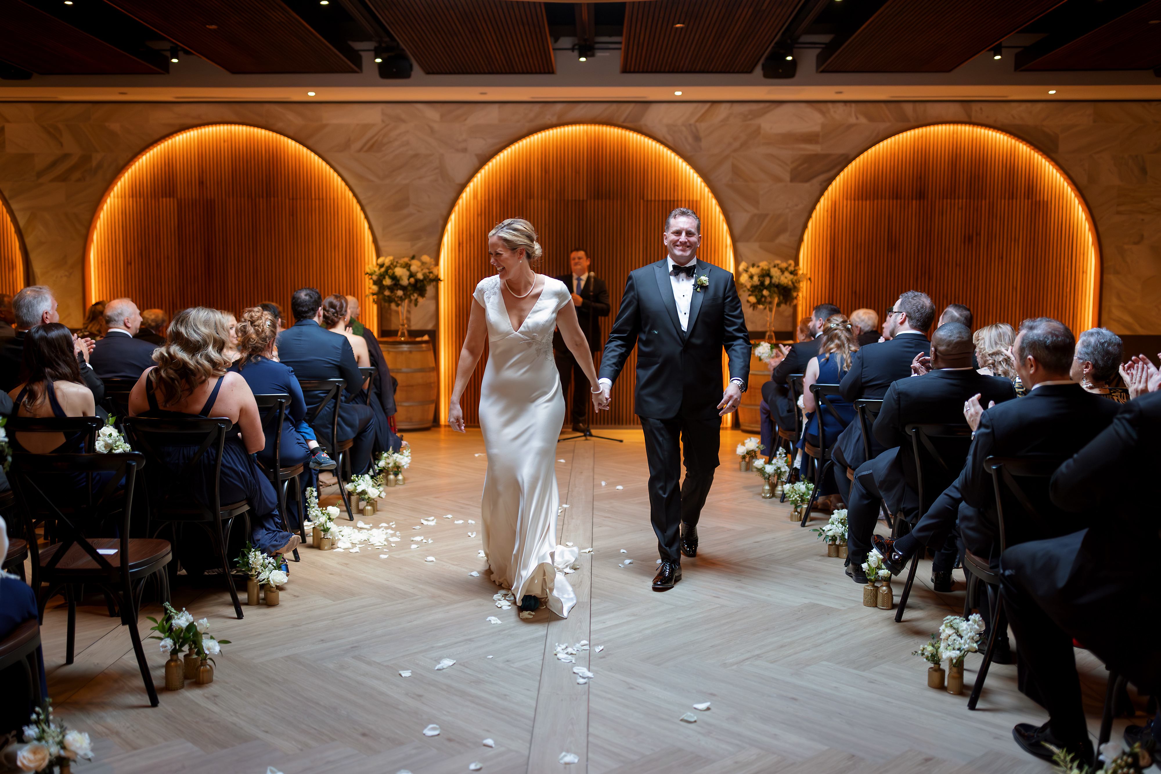 Bride and groom walk back down the aisle after wedding ceremony at Chicago Winery
