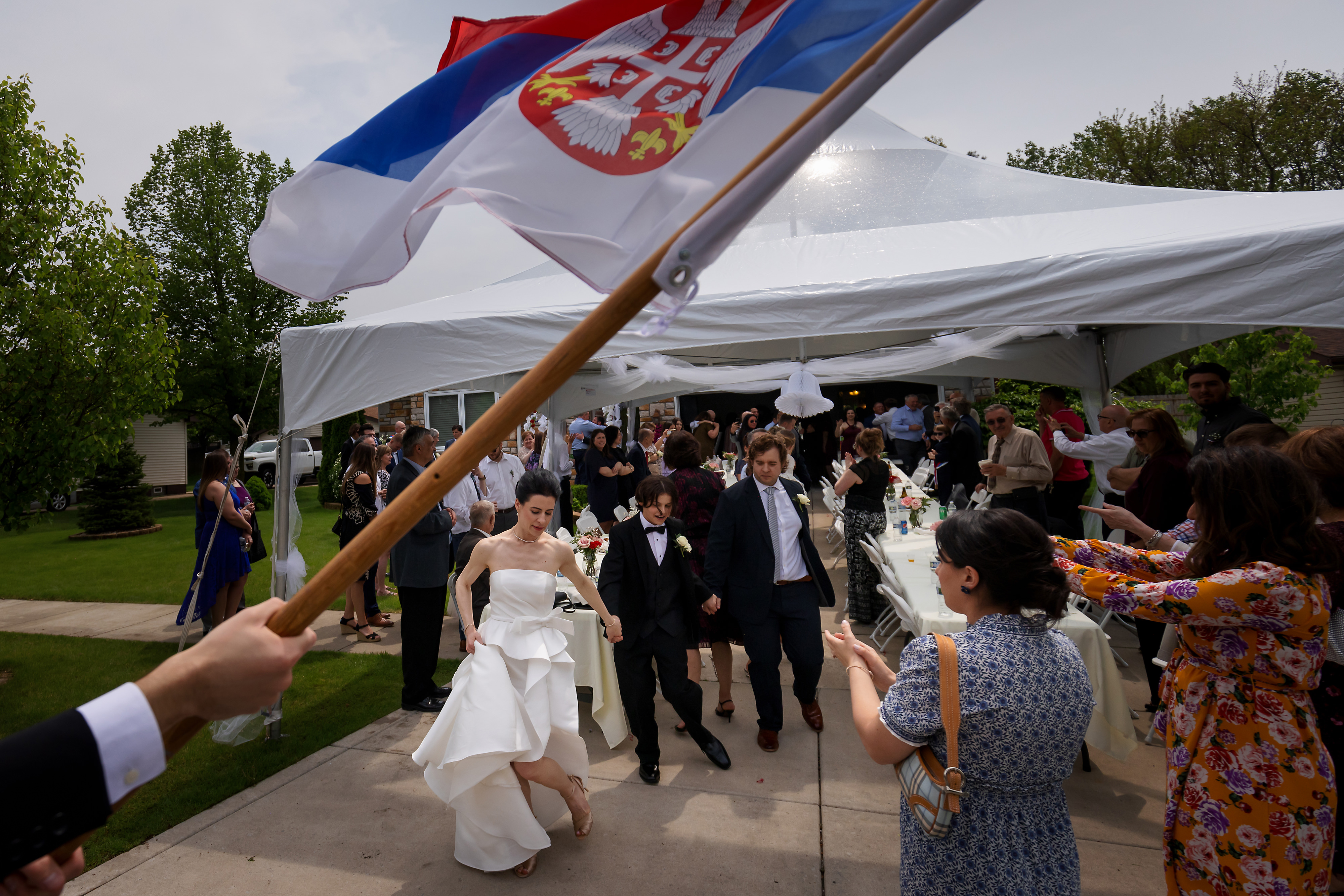 Bride celebrates dancing during Skup before Serbian Orthodox wedding