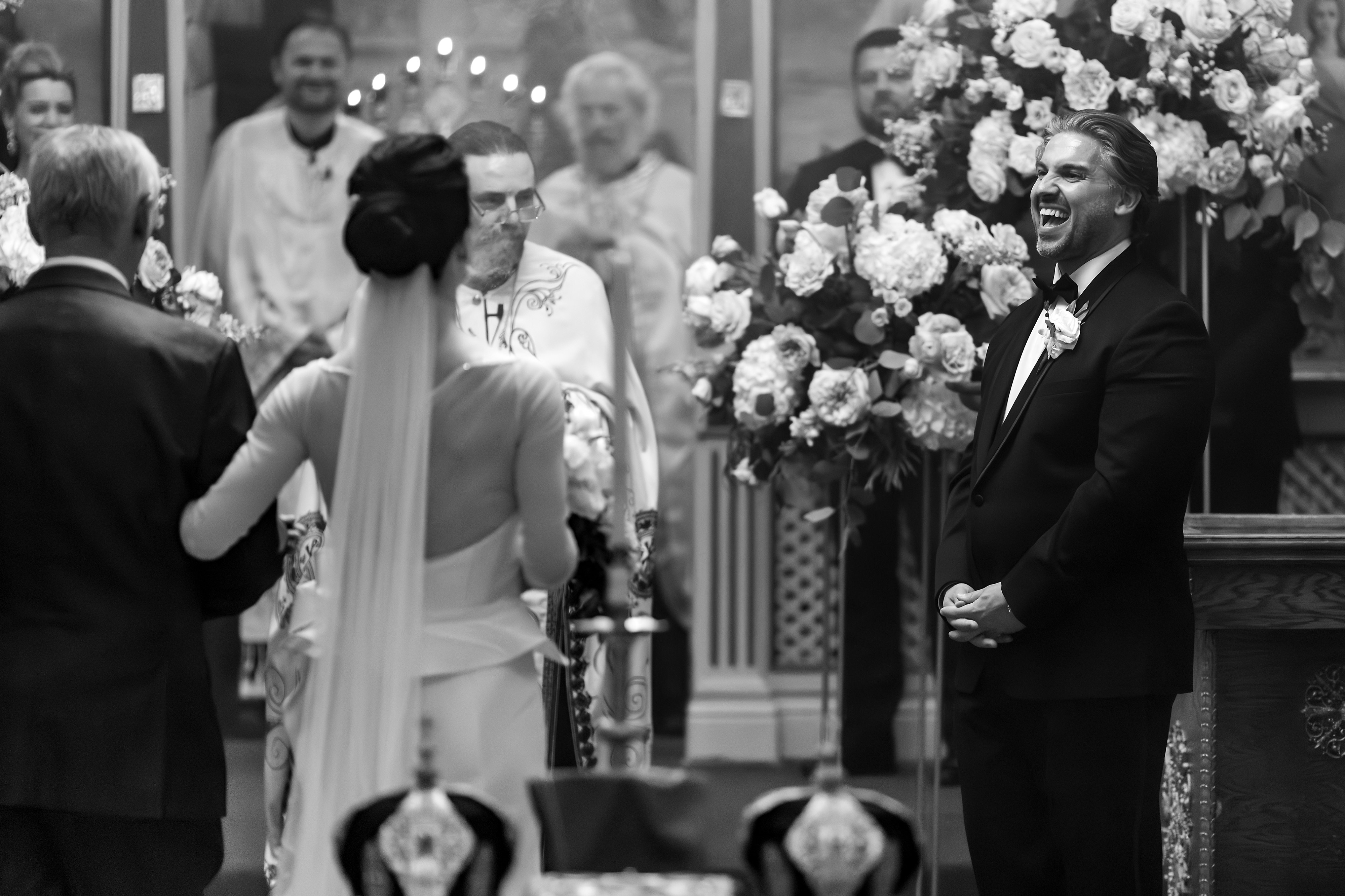 Bride walks down aisle with father during Serbian Orthodox Wedding at St. George church in East Chicago Indiana
