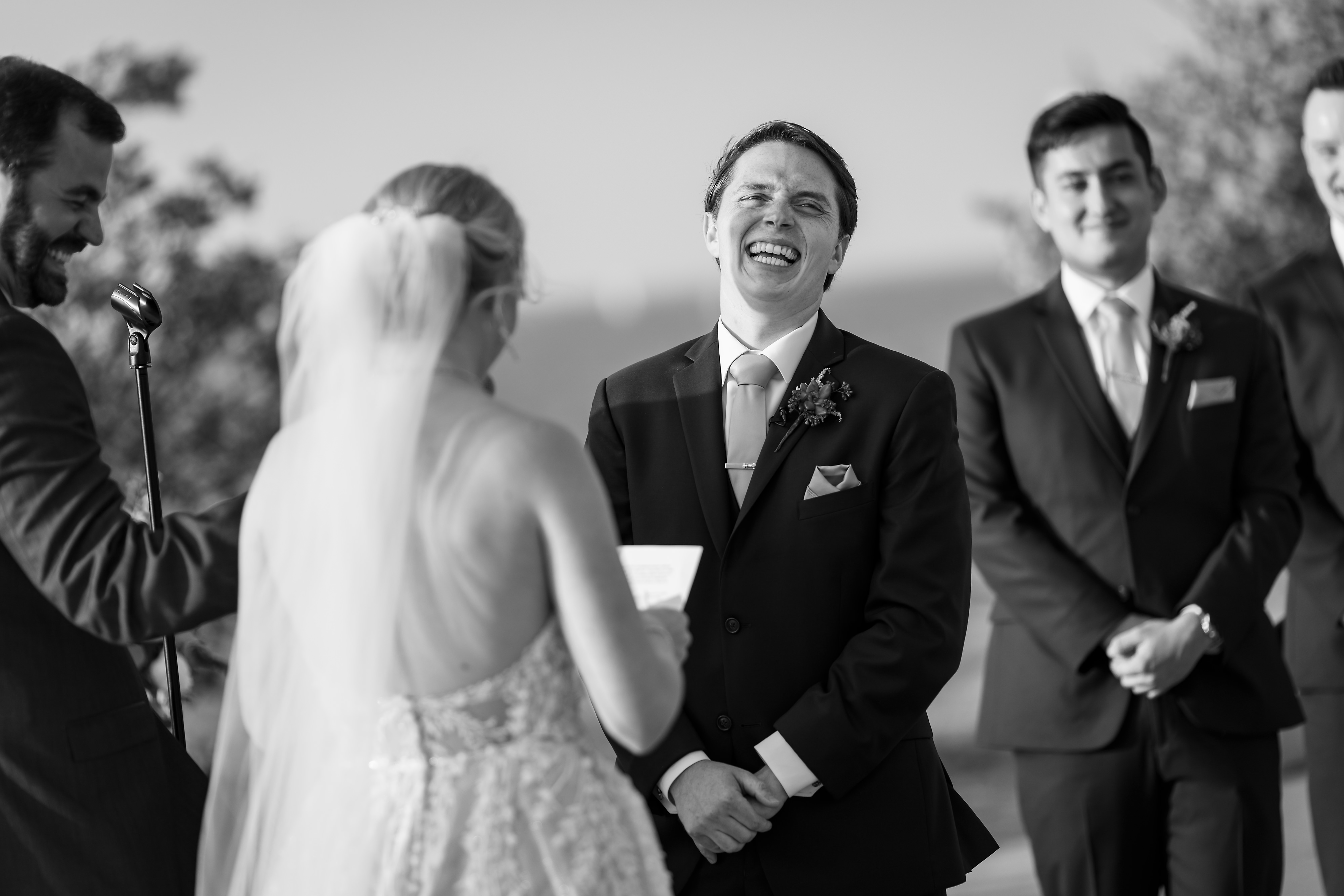groom laughs during wedding ceremony at Adler Planetarium in Chicago