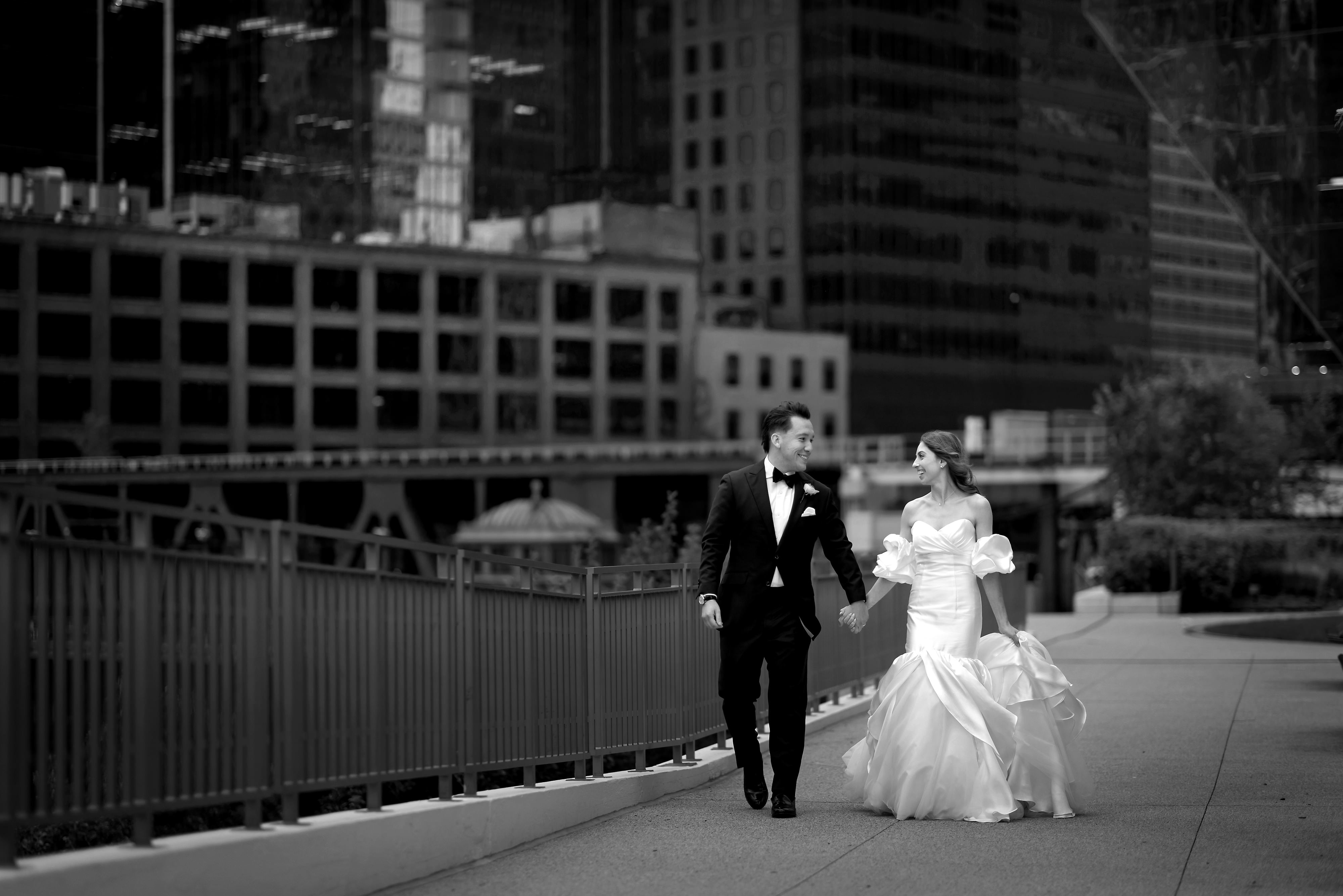 Bride and Groom walking along riverwalk near Gibson's Italia in Chicago