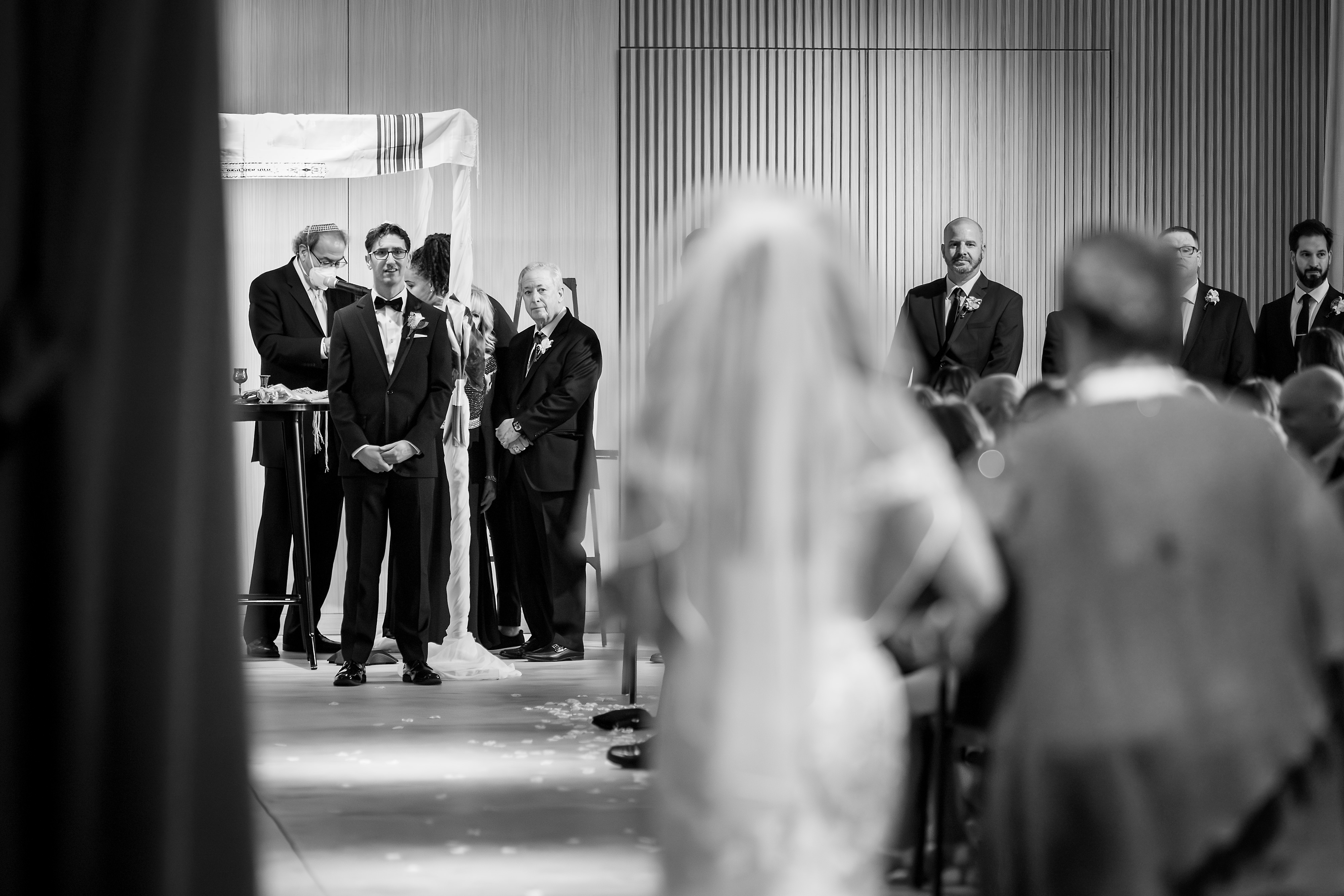 Bride walks down the aisle with groom watching during wedding ceremony at Sarabande in Chicago