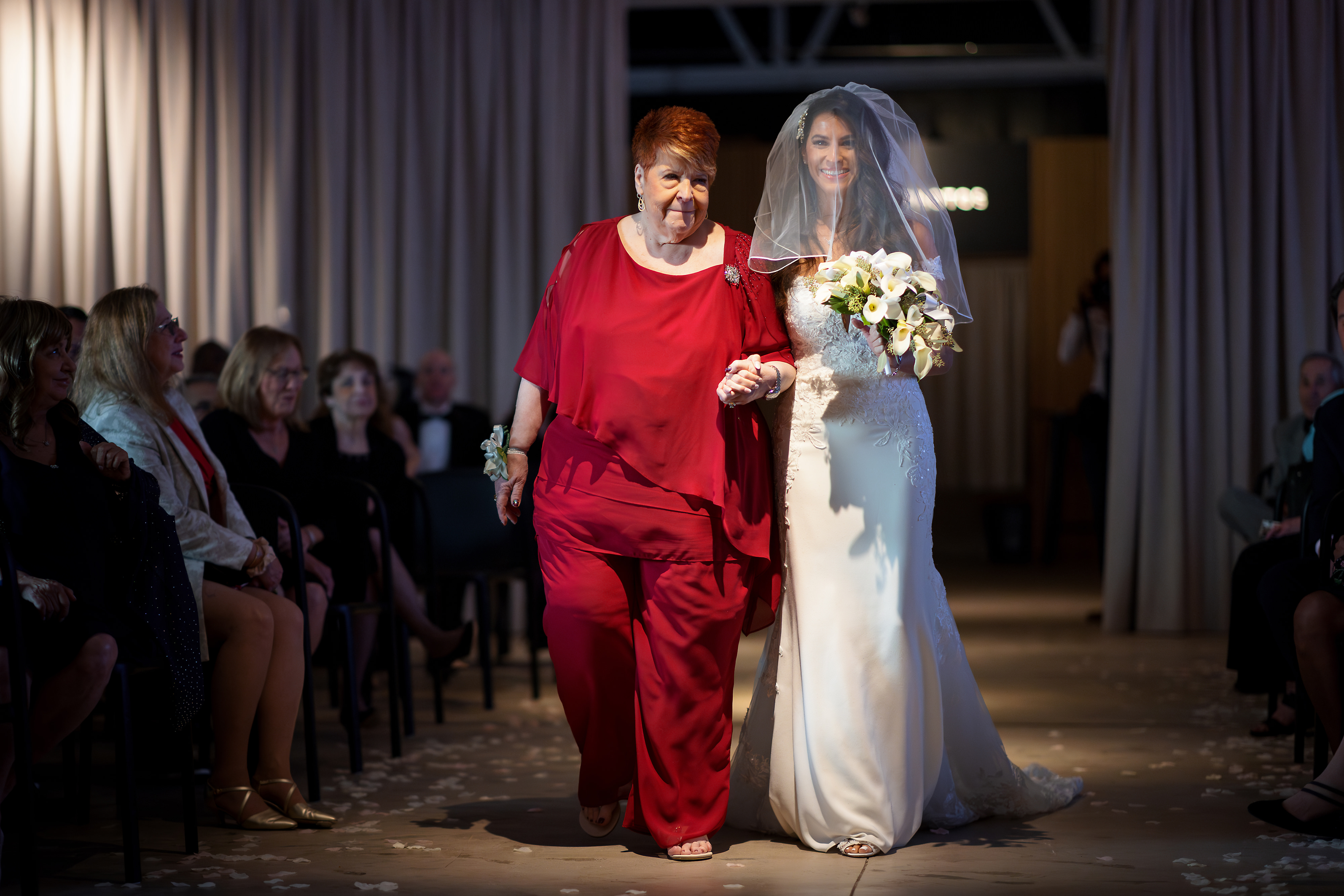 Bride walks down the aisle with mother during wedding ceremony at Sarabande in Chicago