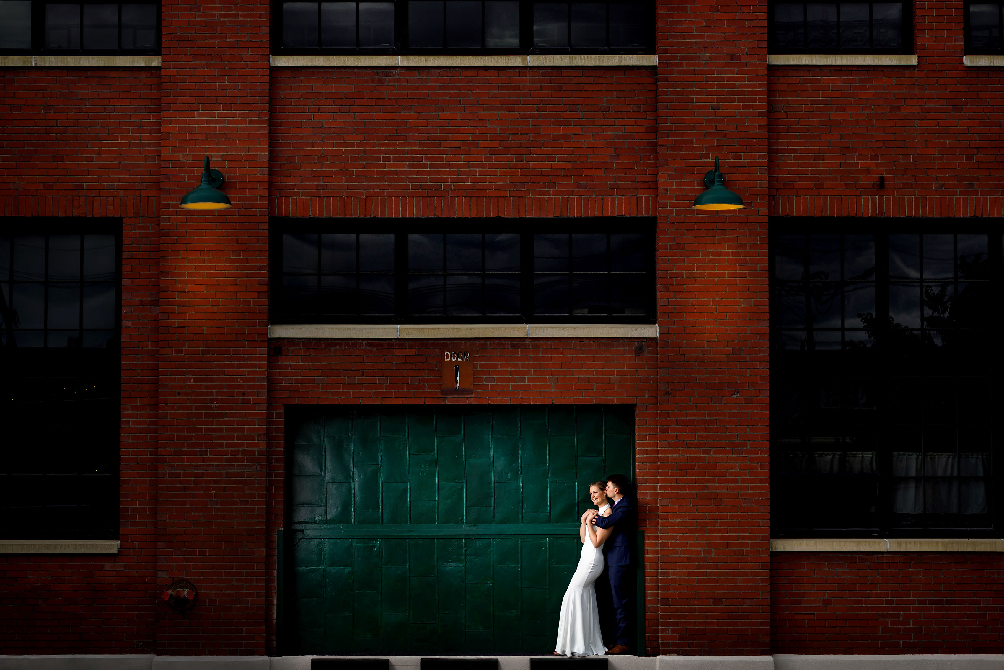 Bride and groom pose for a portrait in an industrial setting