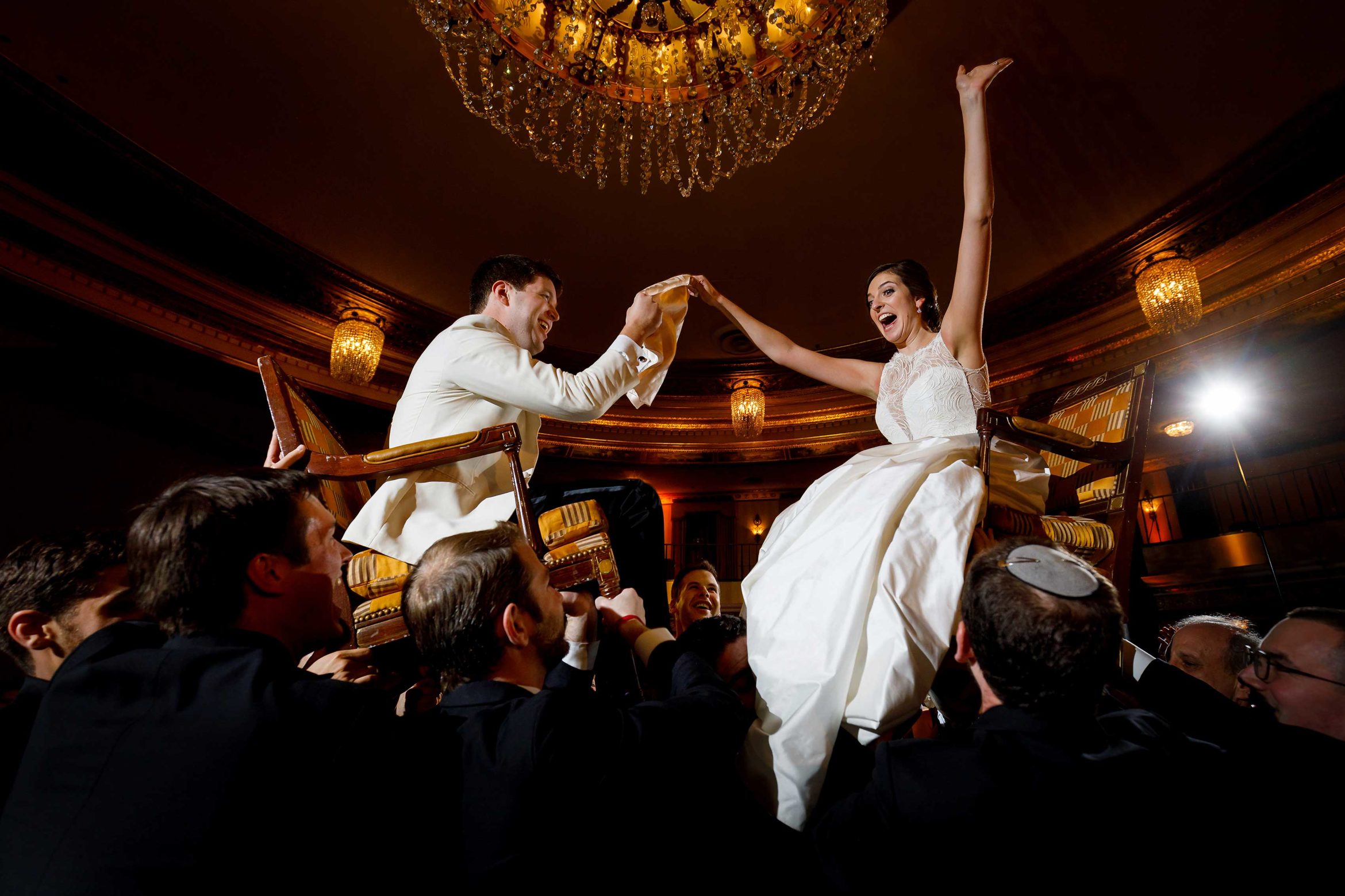 bride-and-groom-are-lifted-onto-chairs-during-the-Horah-during-Jewish-wedding-reception-at-InterContinental-Chicago-Magnificent-Mile-Hotel-31
