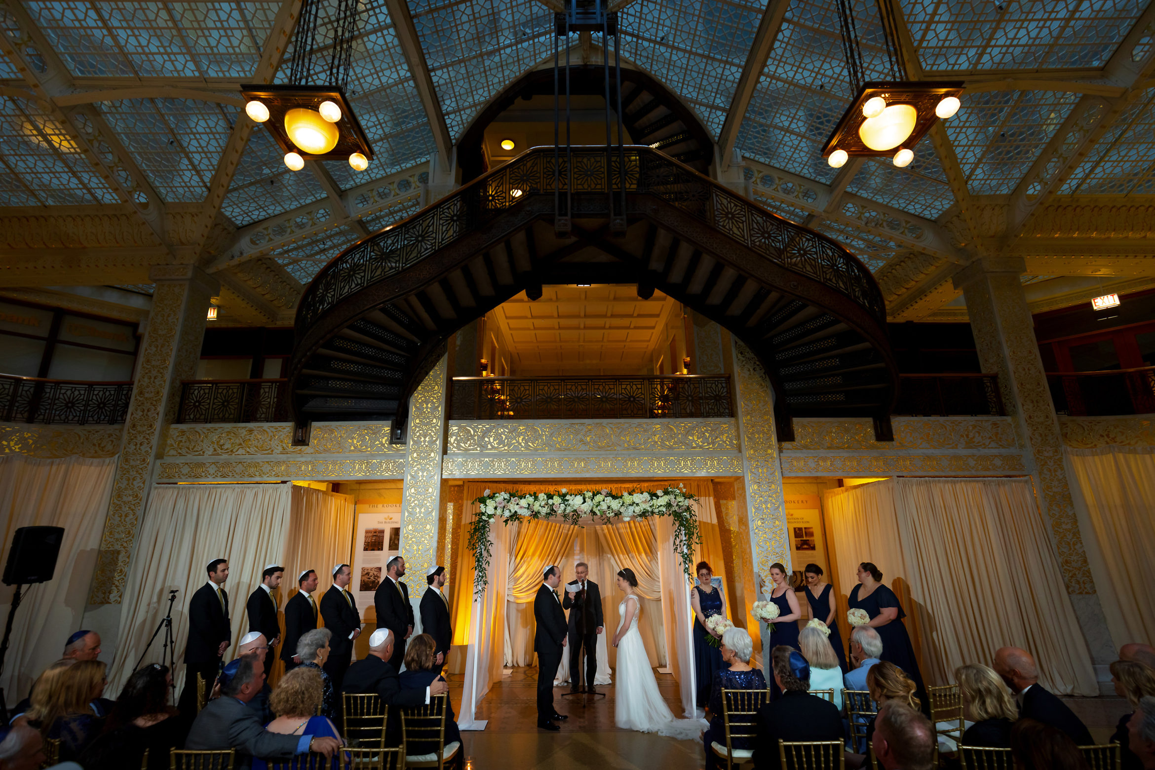 Wide angle shot of wedding ceremony the Rookery Building in downtown Chicago
