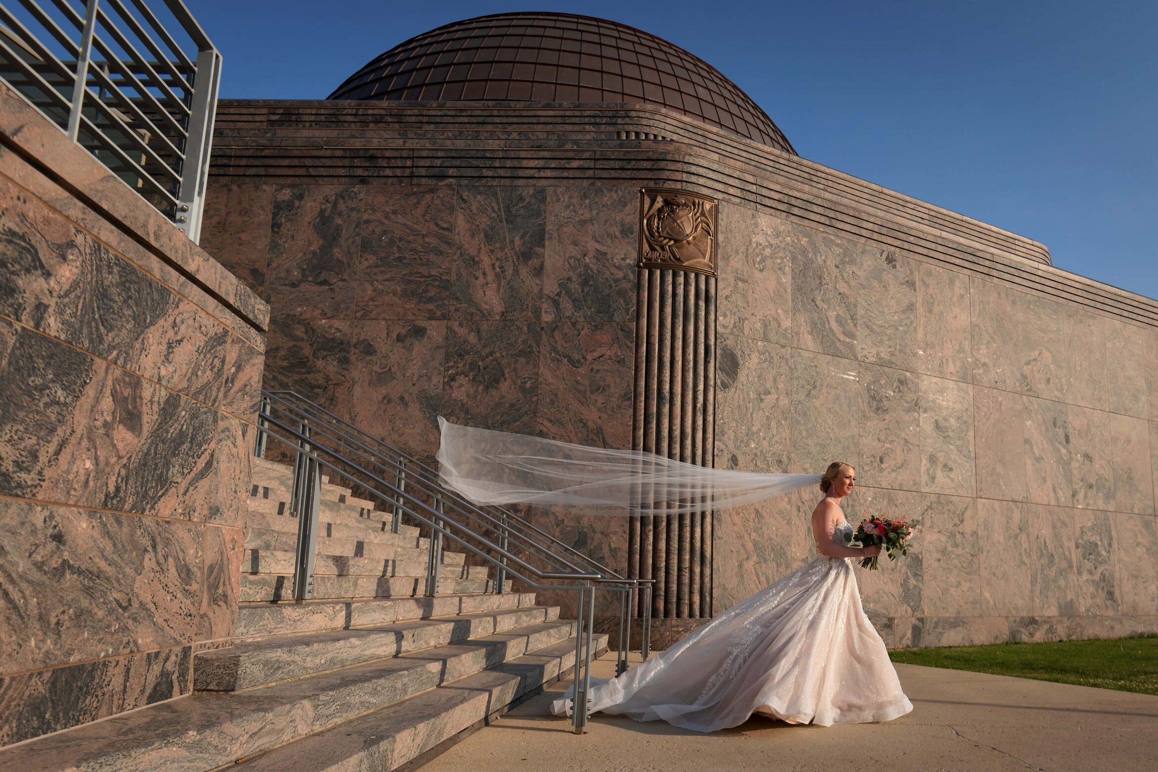 bride walks down stairs during wedding ceremony at Adler Planetarium in Chicago